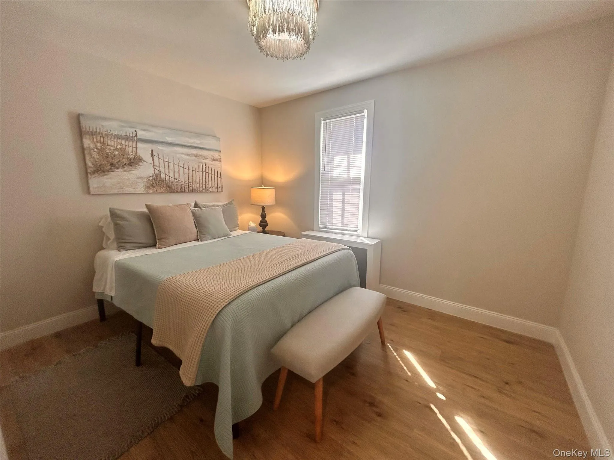 Bedroom featuring baseboards and wood finished floors Bedroom featuring baseboards and wood finished floors