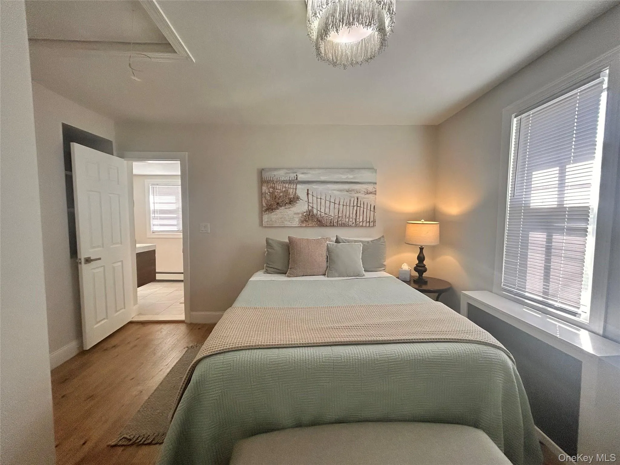Bedroom featuring radiator heating unit and wood finished floors Bedroom featuring radiator heating unit and wood finished floors