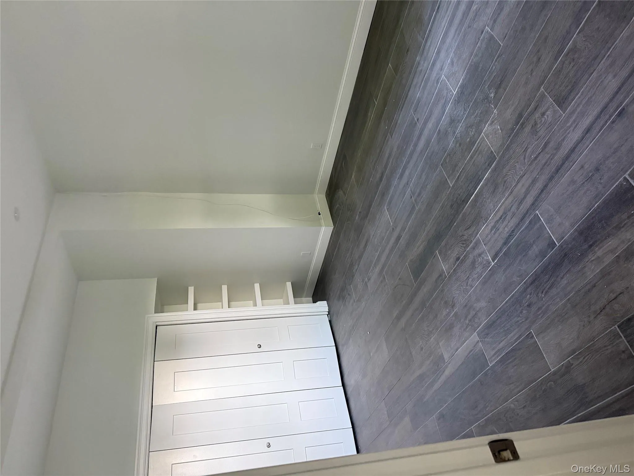 Unfurnished bedroom with dark wood finished floors and a closet Unfurnished bedroom with dark wood finished floors and a closet