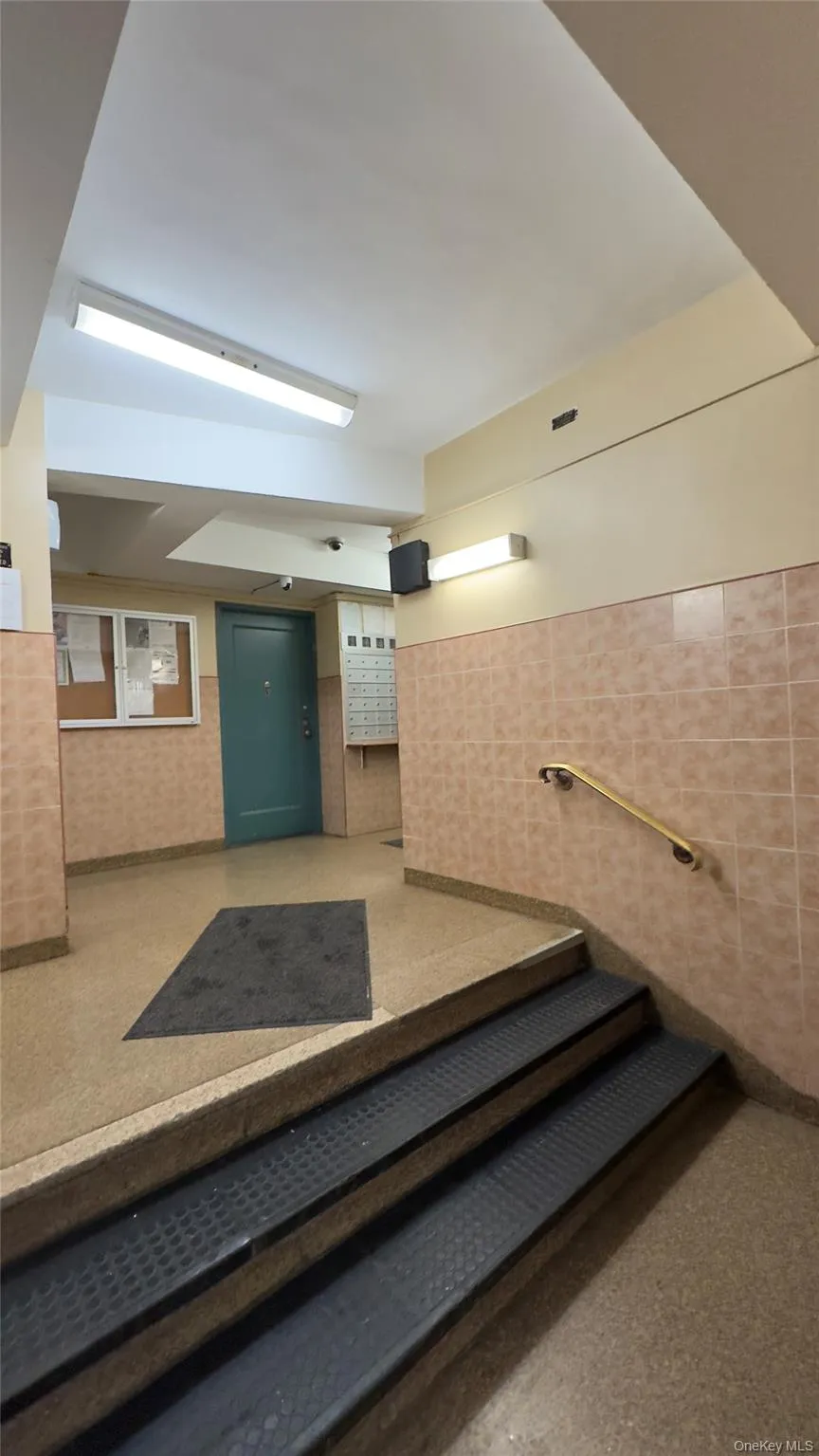 Stairs featuring a wainscoted wall and tile walls Stairs featuring a wainscoted wall and tile walls