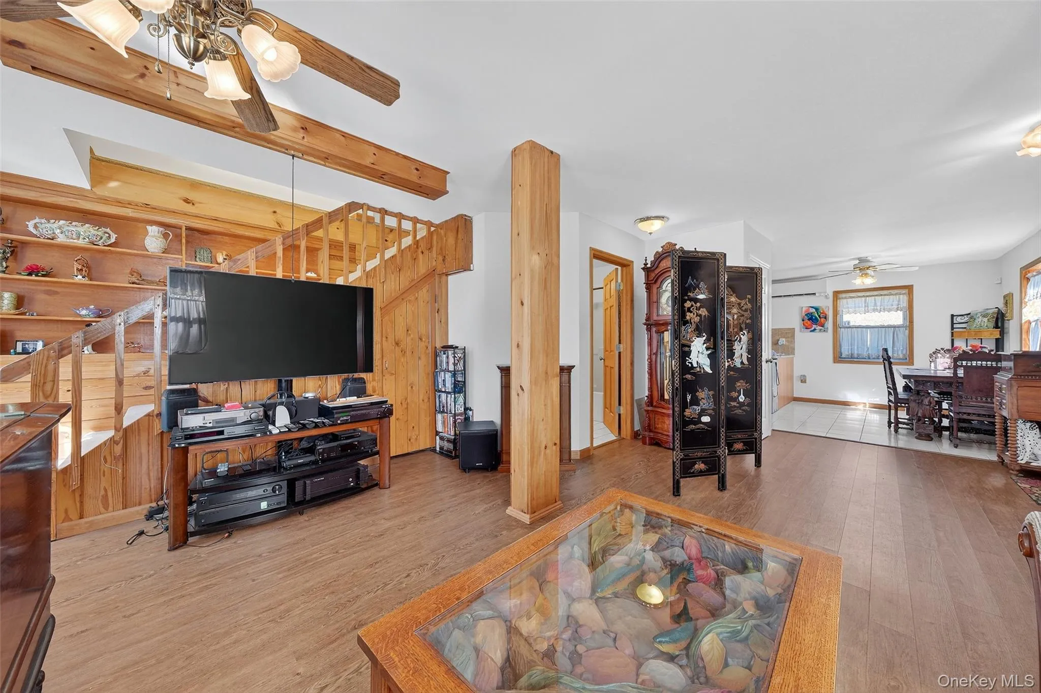 Living room featuring ceiling fan and wood finished floors Living room featuring ceiling fan and wood finished floors