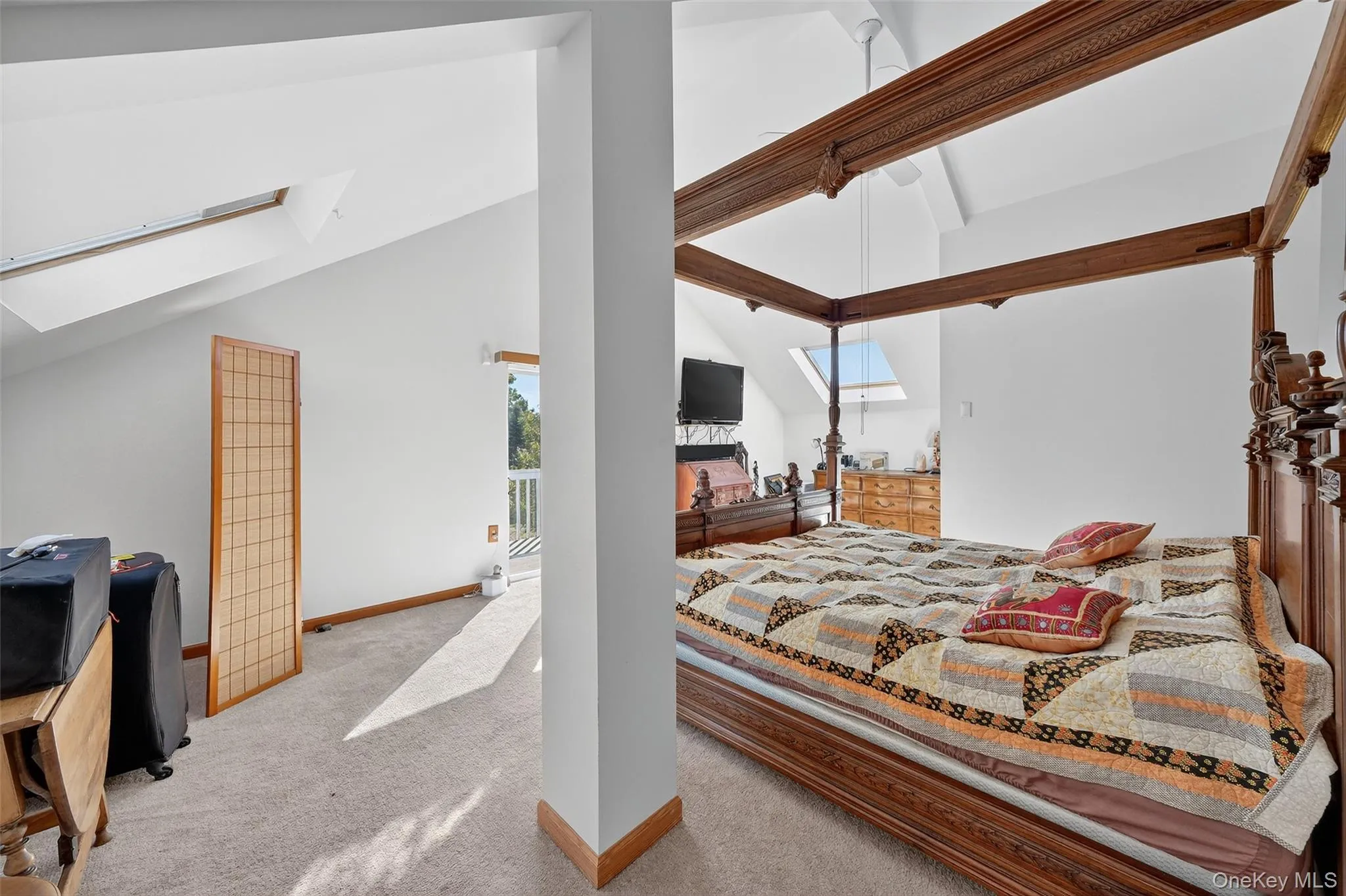 Primary Bedroom with skylights, high ceiling and sliding glass door to balcony Primary Bedroom with skylights, high ceiling and sliding glass door to balcony