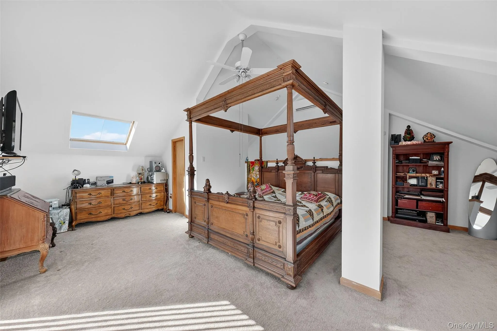 Primary bedroom with skylights, high ceiling and sliding glass door to balcony Primary bedroom with skylights, high ceiling and sliding glass door to balcony