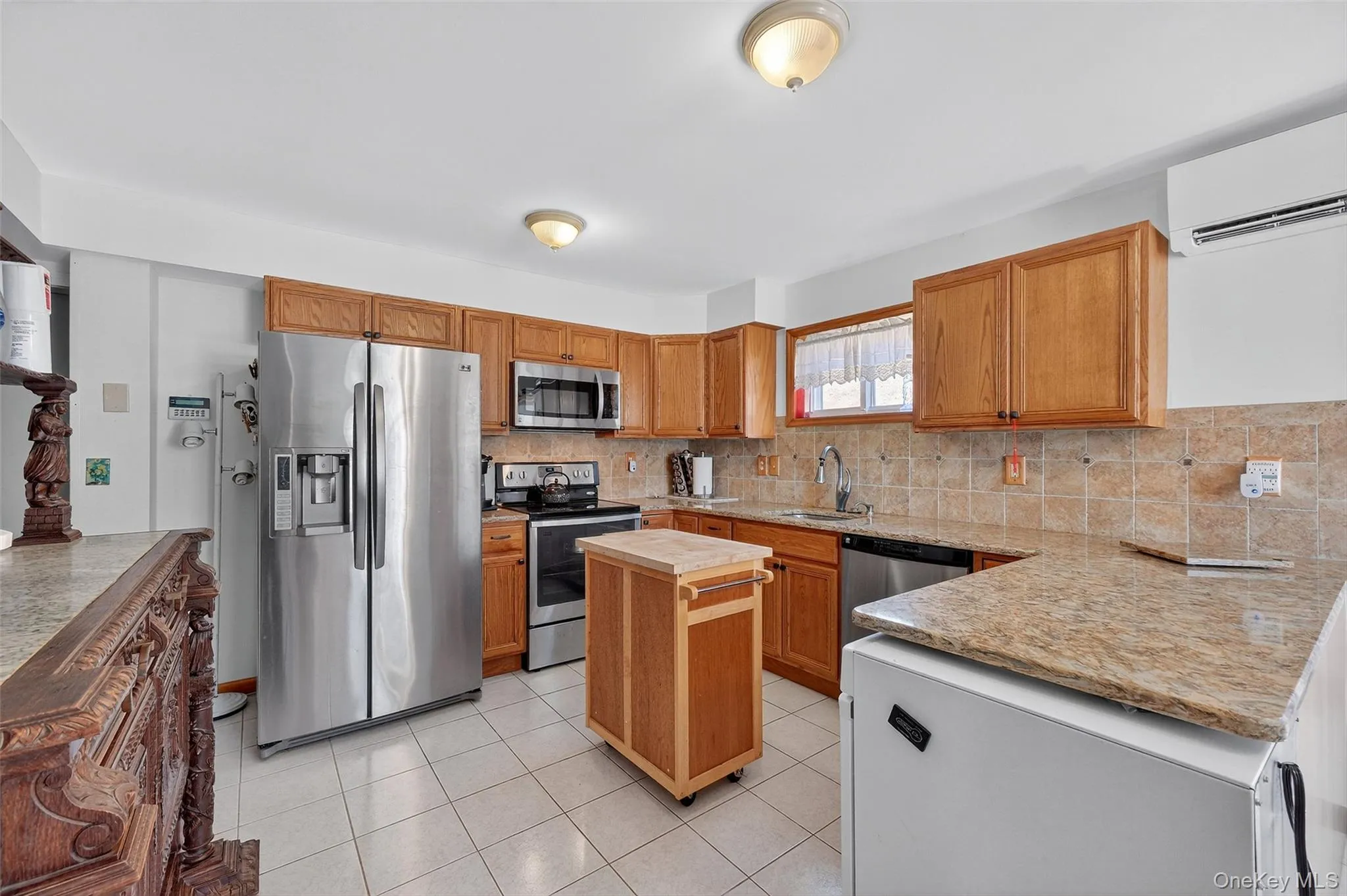 Kitchen with stainless steel appliances, tile floors and granite countertops Kitchen with stainless steel appliances, tile floors and granite countertops