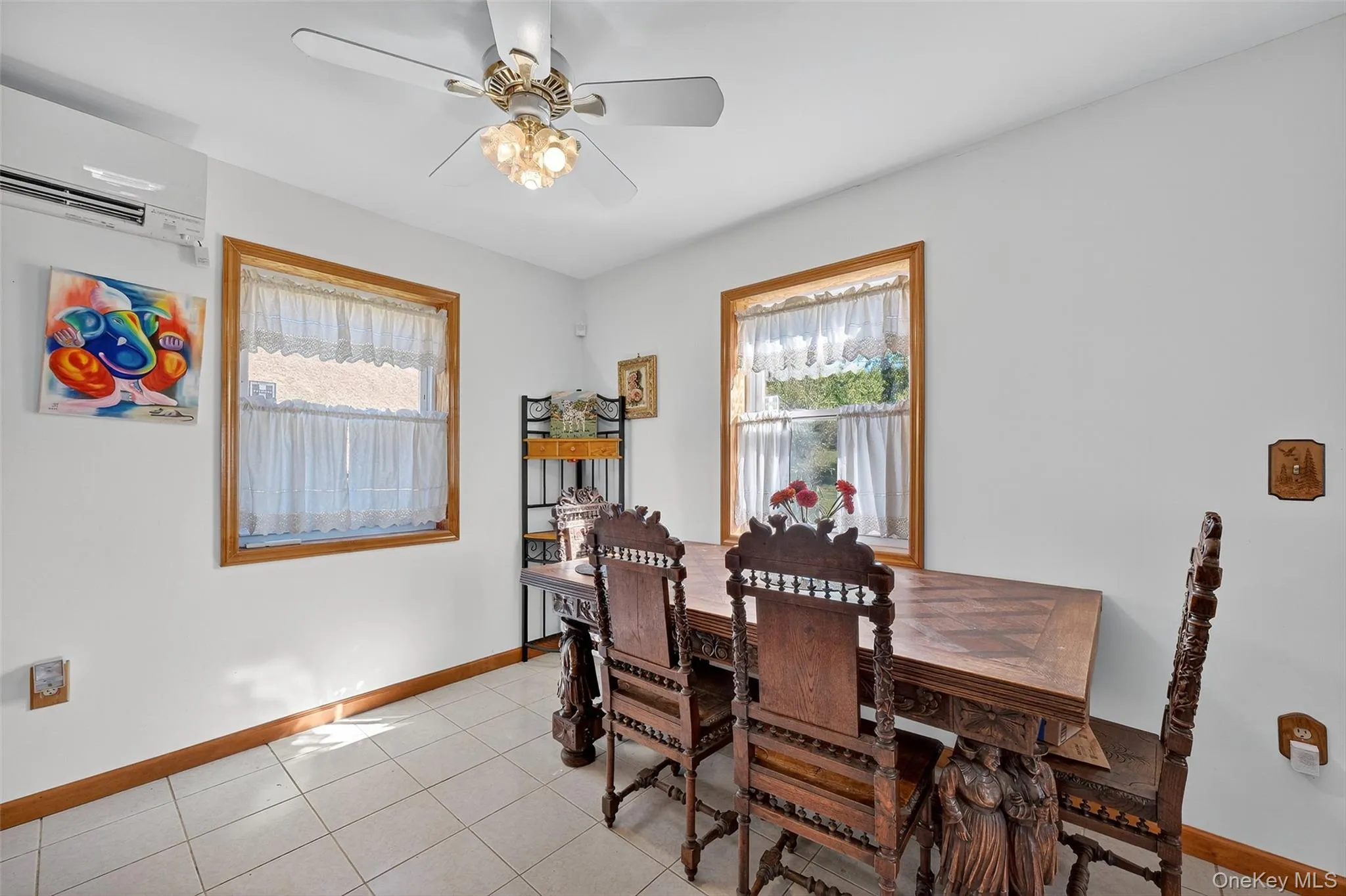 Dining area featuring tile flooring, plenty of natural light and a ceiling fan Dining area featuring tile flooring, plenty of natural light and a ceiling fan