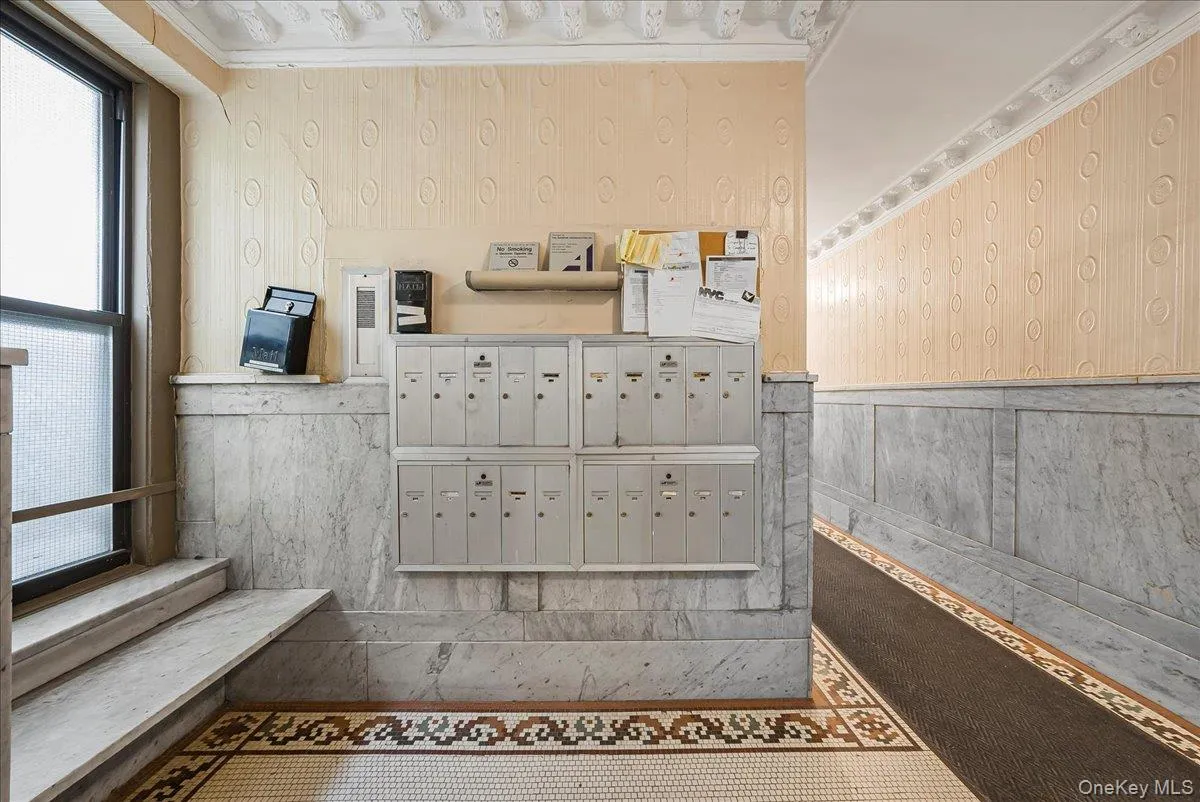Surrounding community featuring mail area, wallpapered walls, and a wainscoted wall Surrounding community featuring mail area, wallpapered walls, and a wainscoted wall