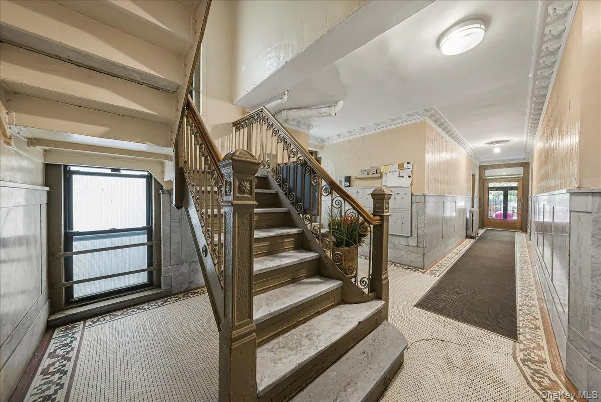 Stairs featuring a wainscoted wall Stairs featuring a wainscoted wall