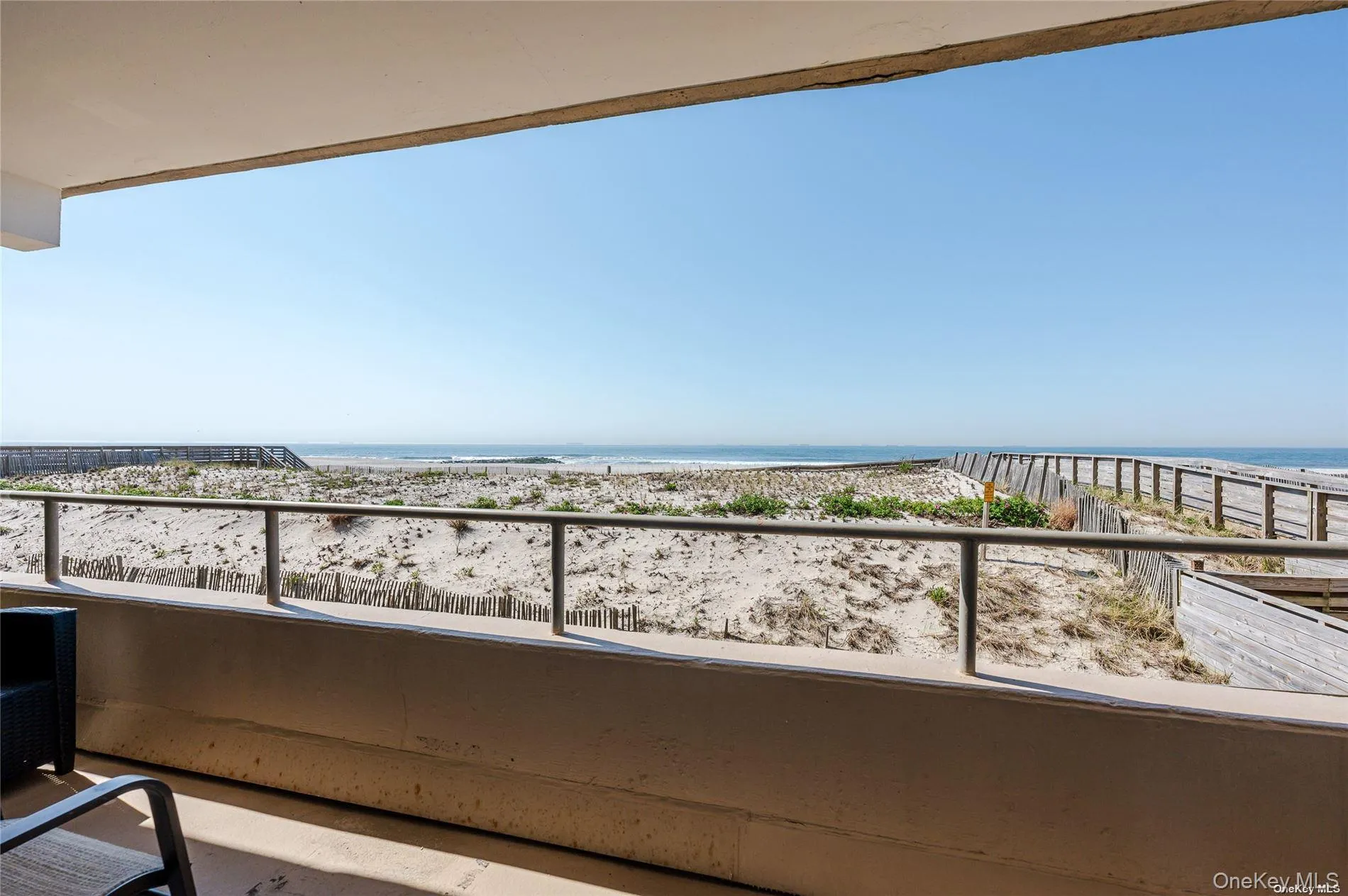 Balcony featuring view of water and beach Balcony featuring view of water and beach