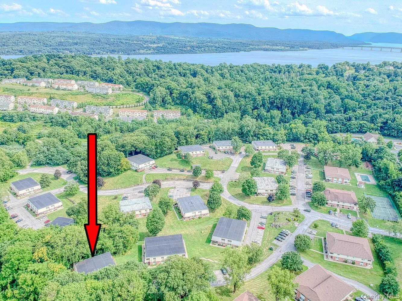 Aerial view of a mountain backdrop and a heavily wooded area Aerial view of a mountain backdrop and a heavily wooded area