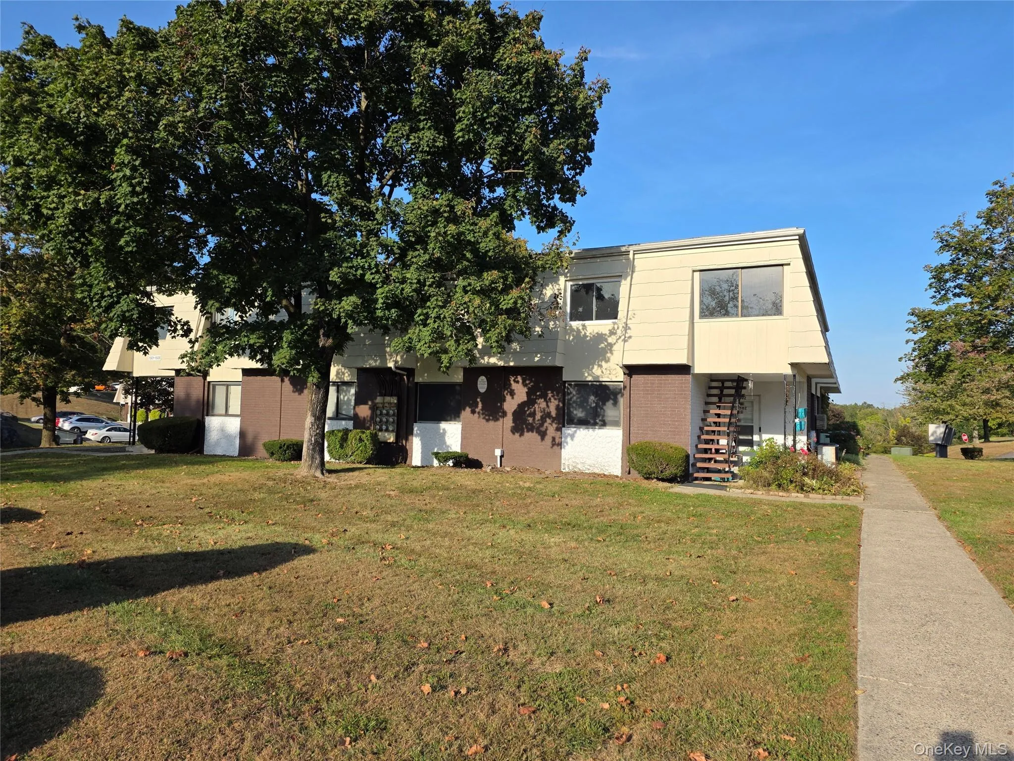 View of front of property with stairs, a front lawn, and brick siding View of front of property with stairs, a front lawn, and brick siding