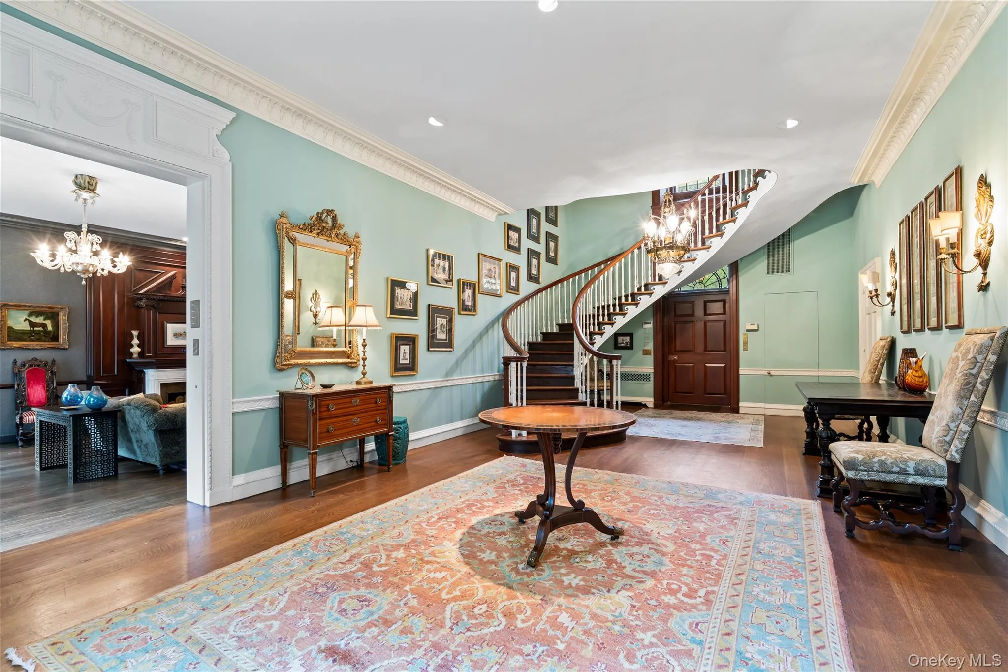 Entrance foyer featuring a chandelier, crown molding, dark wood-style flooring, recessed lighting, and stairs Entrance foyer featuring a chandelier, crown molding, dark wood-style flooring, recessed lighting, and stairs
