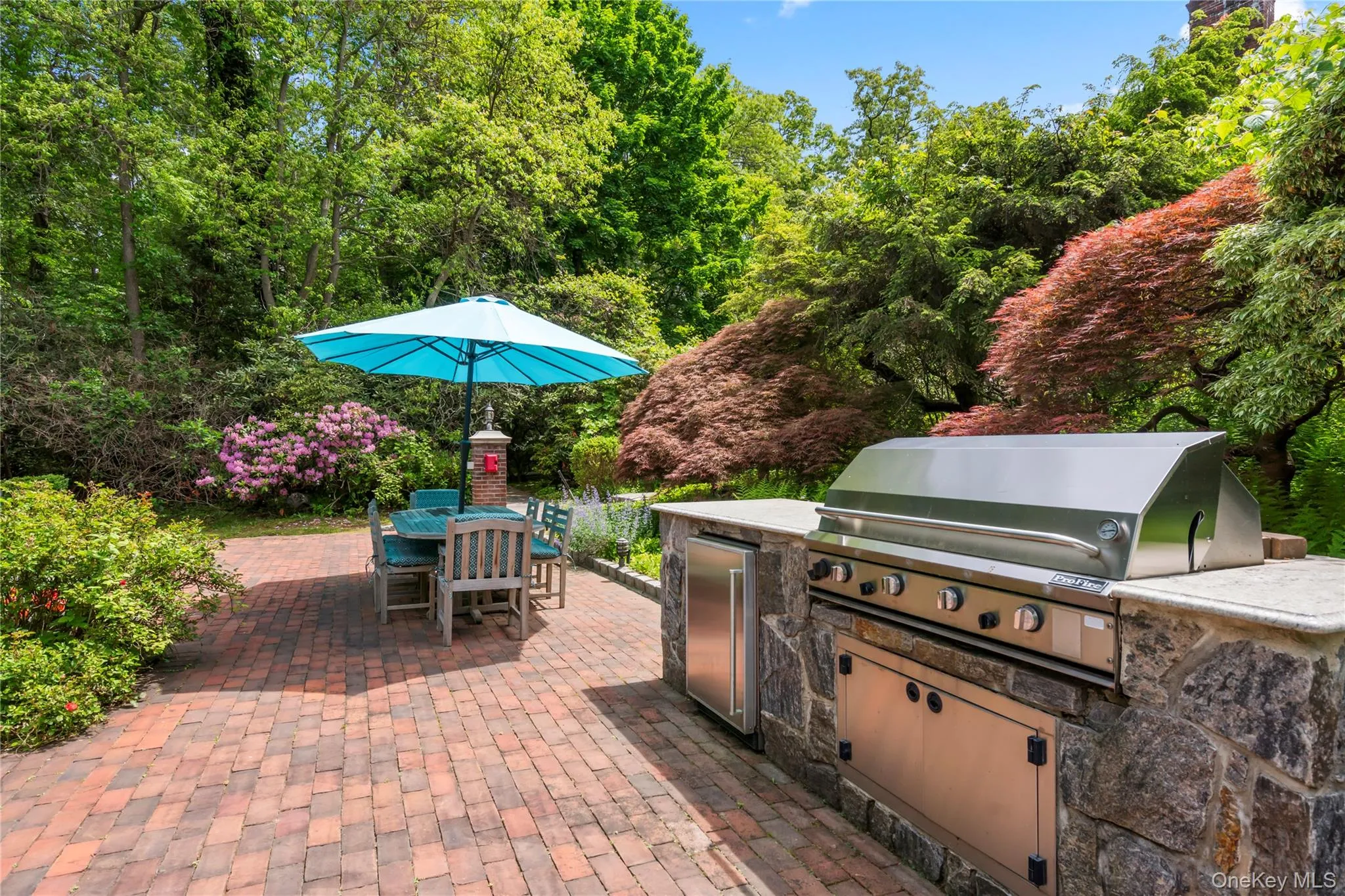View of patio / terrace featuring outdoor dining area and exterior kitchen View of patio / terrace featuring outdoor dining area and exterior kitchen