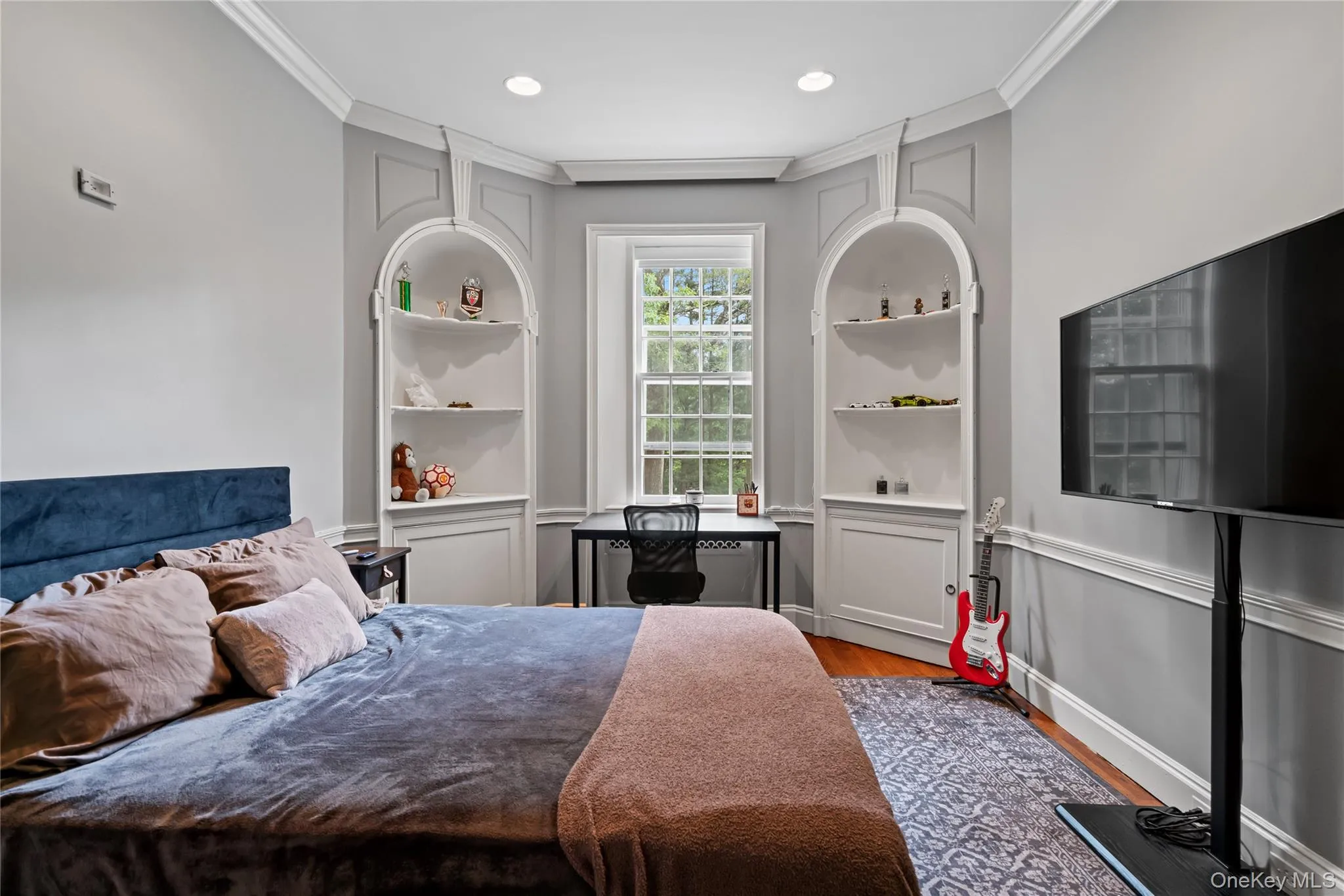 Bedroom featuring wood finished floors, crown molding, and recessed lighting Bedroom featuring wood finished floors, crown molding, and recessed lighting