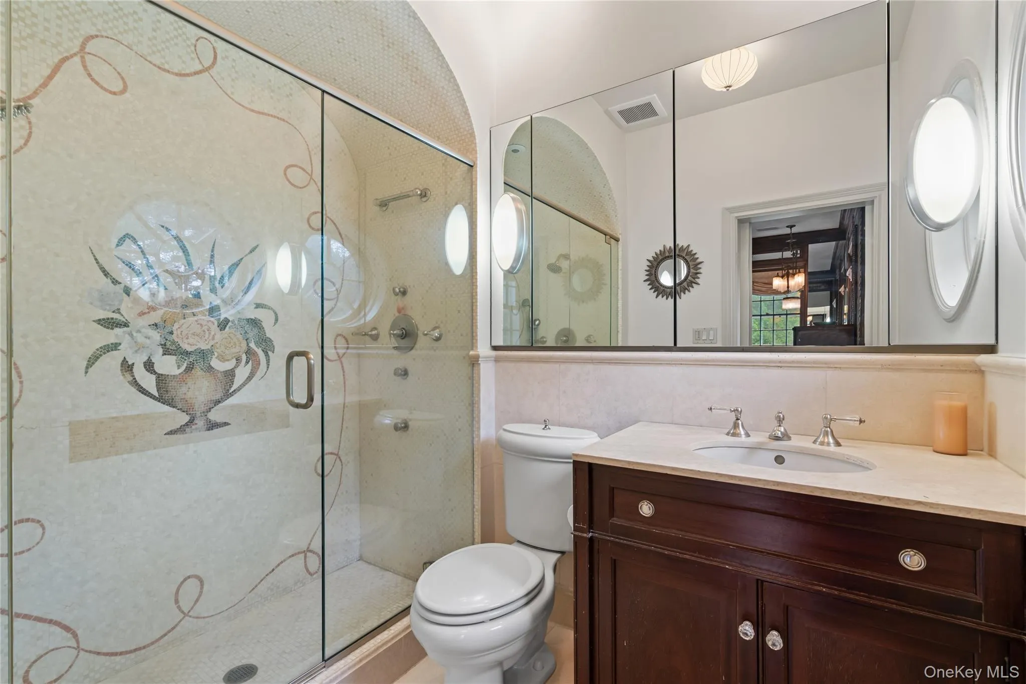 Full bath featuring a stall shower, vanity, and tile walls Full bath featuring a stall shower, vanity, and tile walls