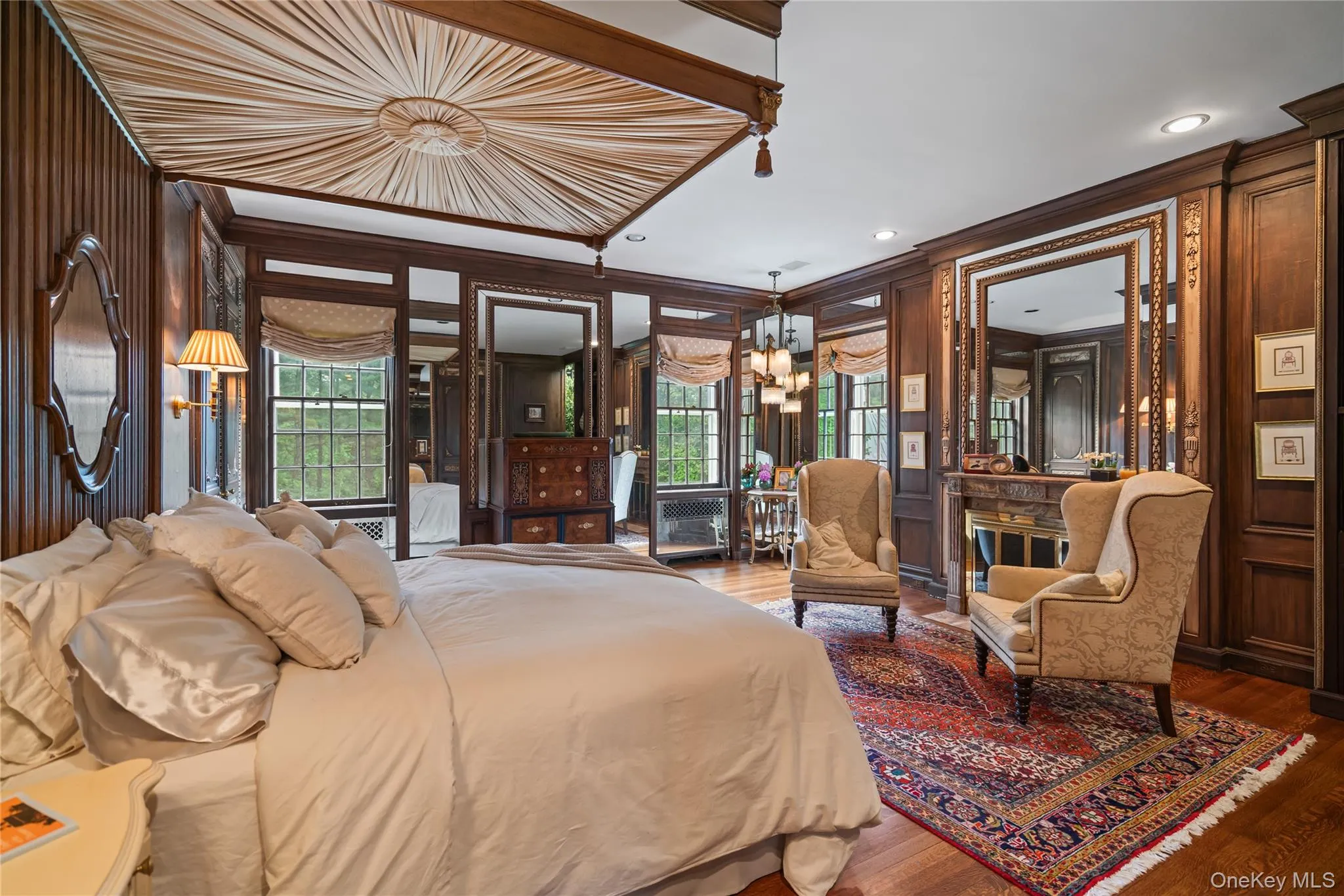 Bedroom with ornamental molding, a chandelier, wood finished floors, multiple windows, and recessed lighting Bedroom with ornamental molding, a chandelier, wood finished floors, multiple windows, and recessed lighting