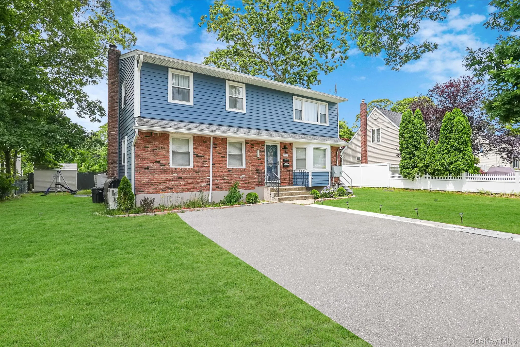View of front of home featuring a chimney and brick siding View of front of home featuring a chimney and brick siding