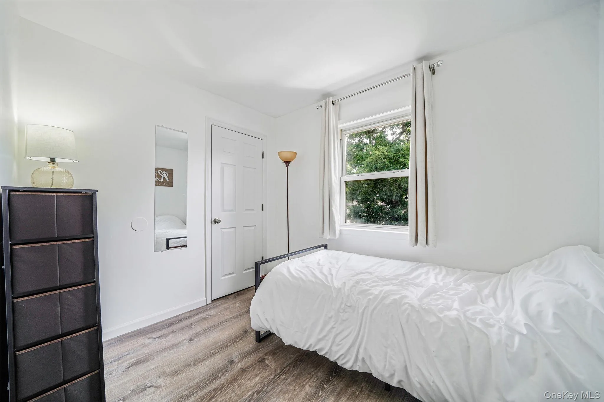 Bedroom with wood finished floors and baseboards Bedroom with wood finished floors and baseboards