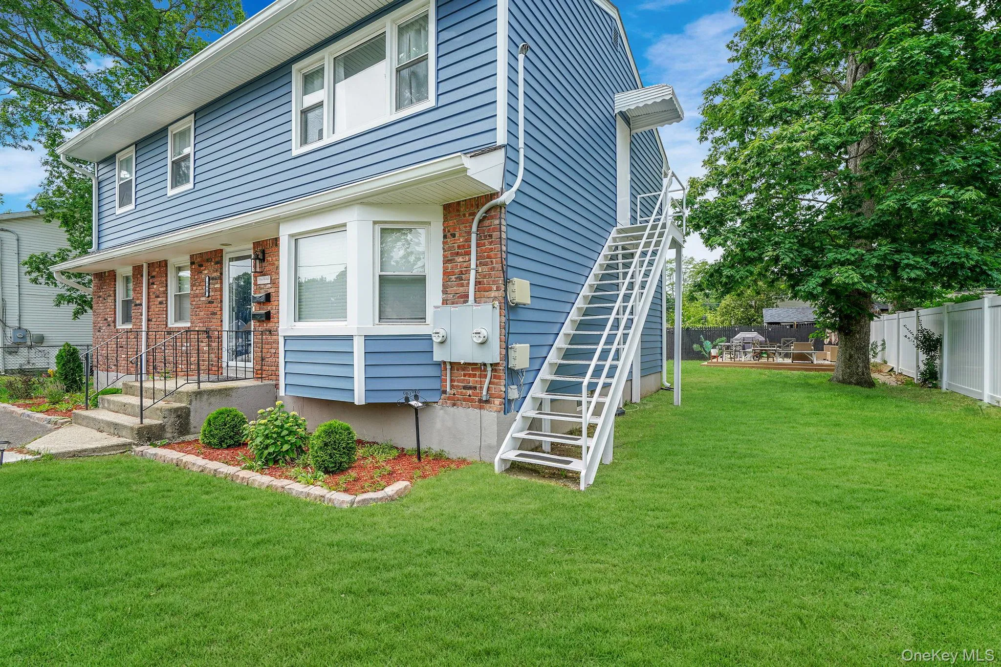 View of front of property featuring stairs and brick siding View of front of property featuring stairs and brick siding