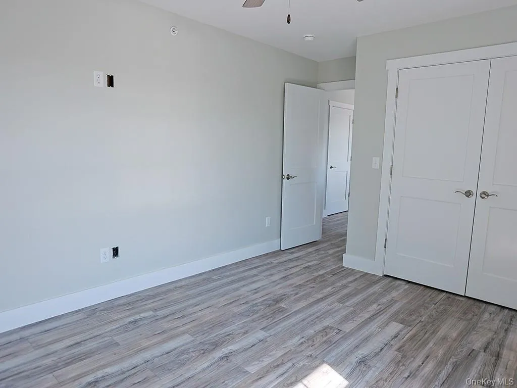Unfurnished bedroom with light wood-style flooring, ceiling fan, and a closet Unfurnished bedroom with light wood-style flooring, ceiling fan, and a closet