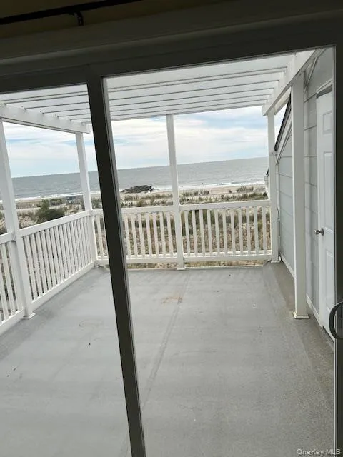Balcony with view of water and beach Balcony with view of water and beach