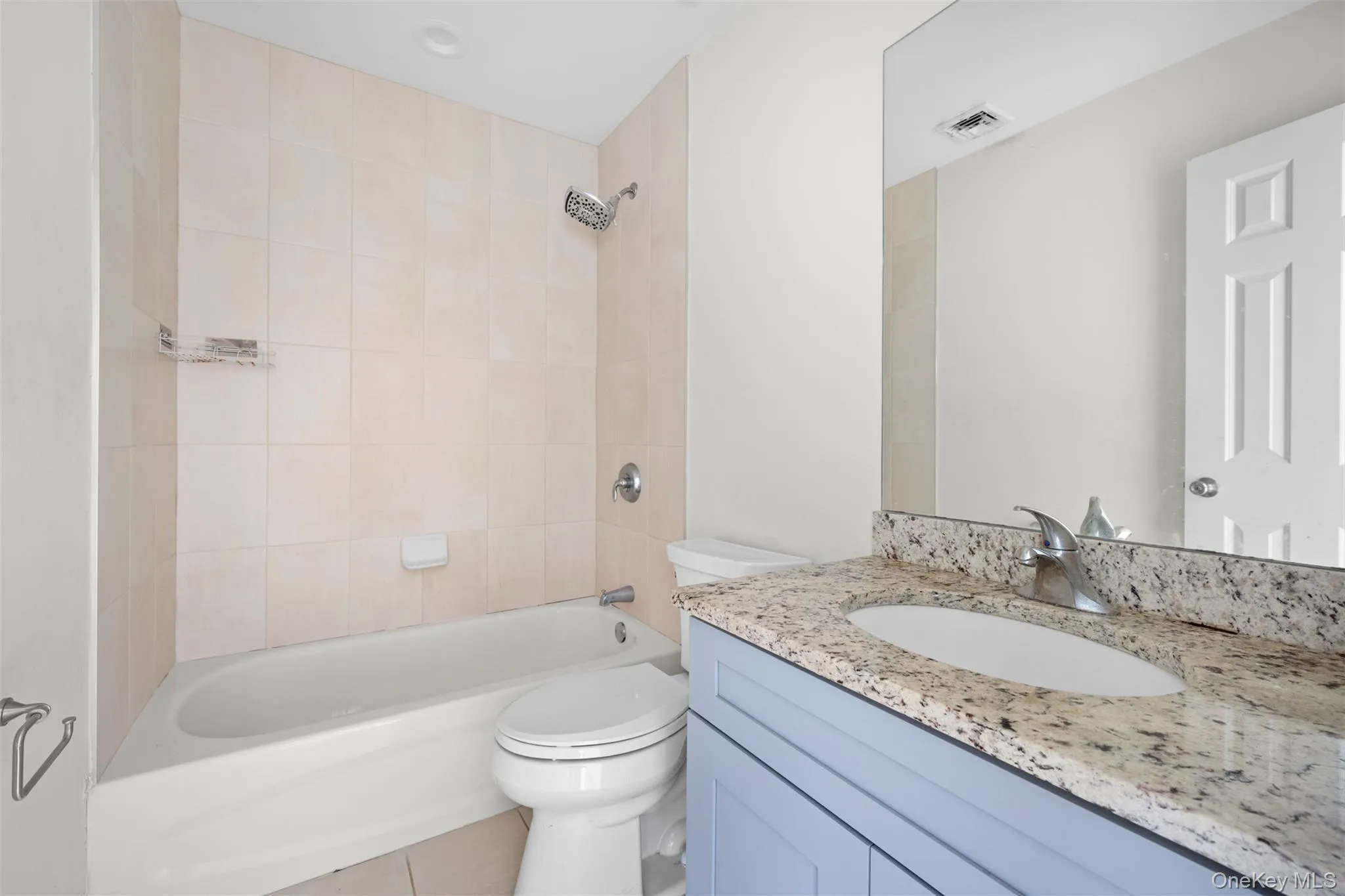 Full bath featuring vanity, shower / washtub combination, and tile patterned floors Full bath featuring vanity, shower / washtub combination, and tile patterned floors