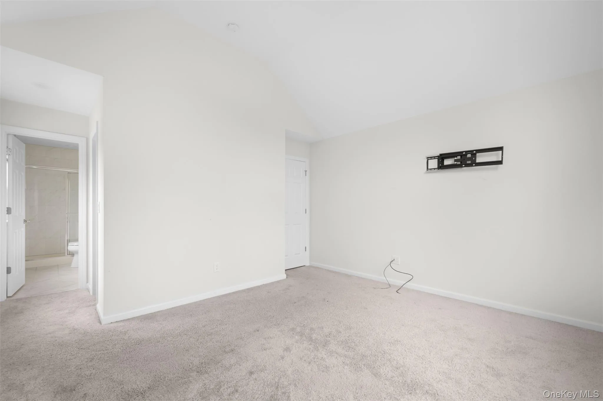 Spare room with carpet floors and vaulted ceiling Spare room with carpet floors and vaulted ceiling