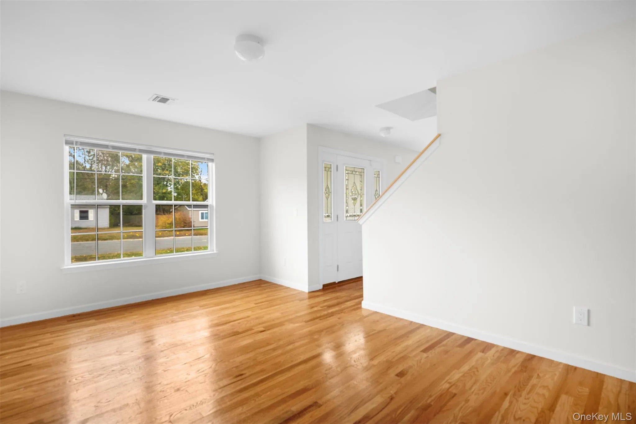 Unfurnished room with light wood-style floors and baseboards Unfurnished room with light wood-style floors and baseboards