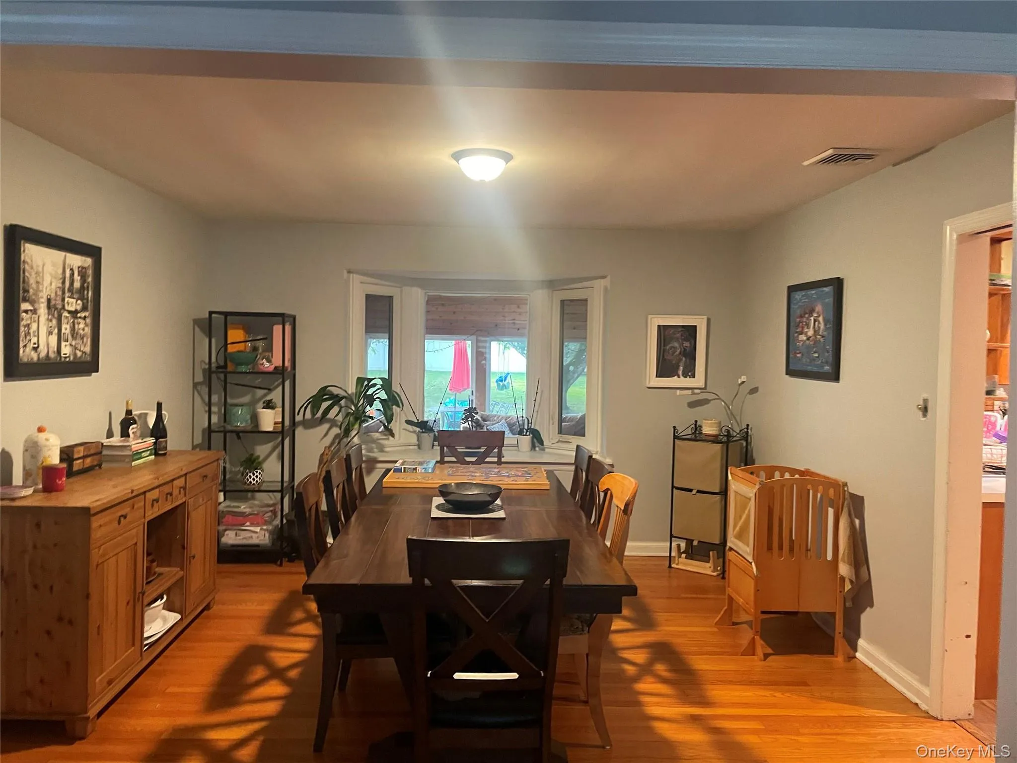 Dining room with light wood-style floors and baseboards Dining room with light wood-style floors and baseboards
