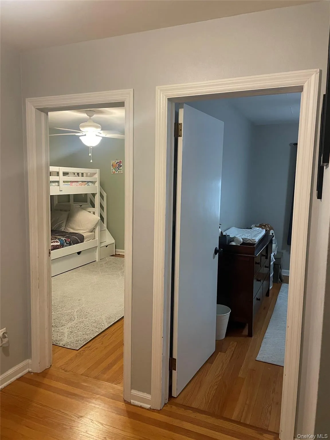 Hallway with light wood-style flooring and baseboards Hallway with light wood-style flooring and baseboards