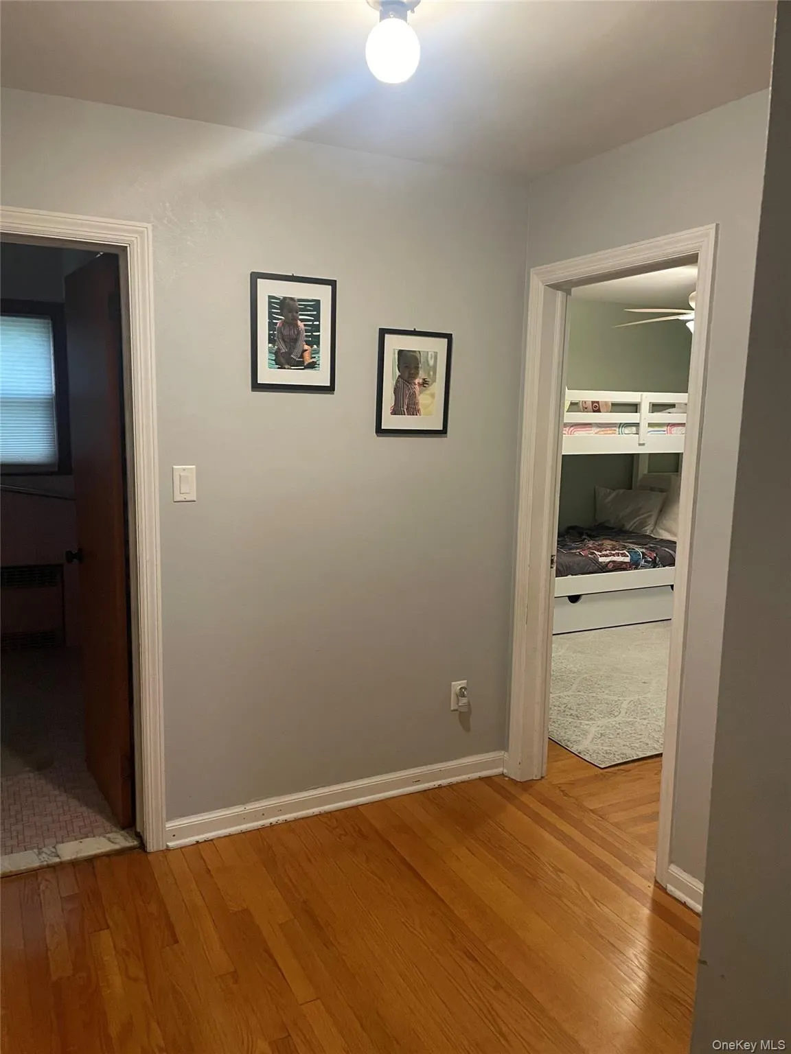 Hall featuring light wood-style floors and radiator heating unit Hall featuring light wood-style floors and radiator heating unit