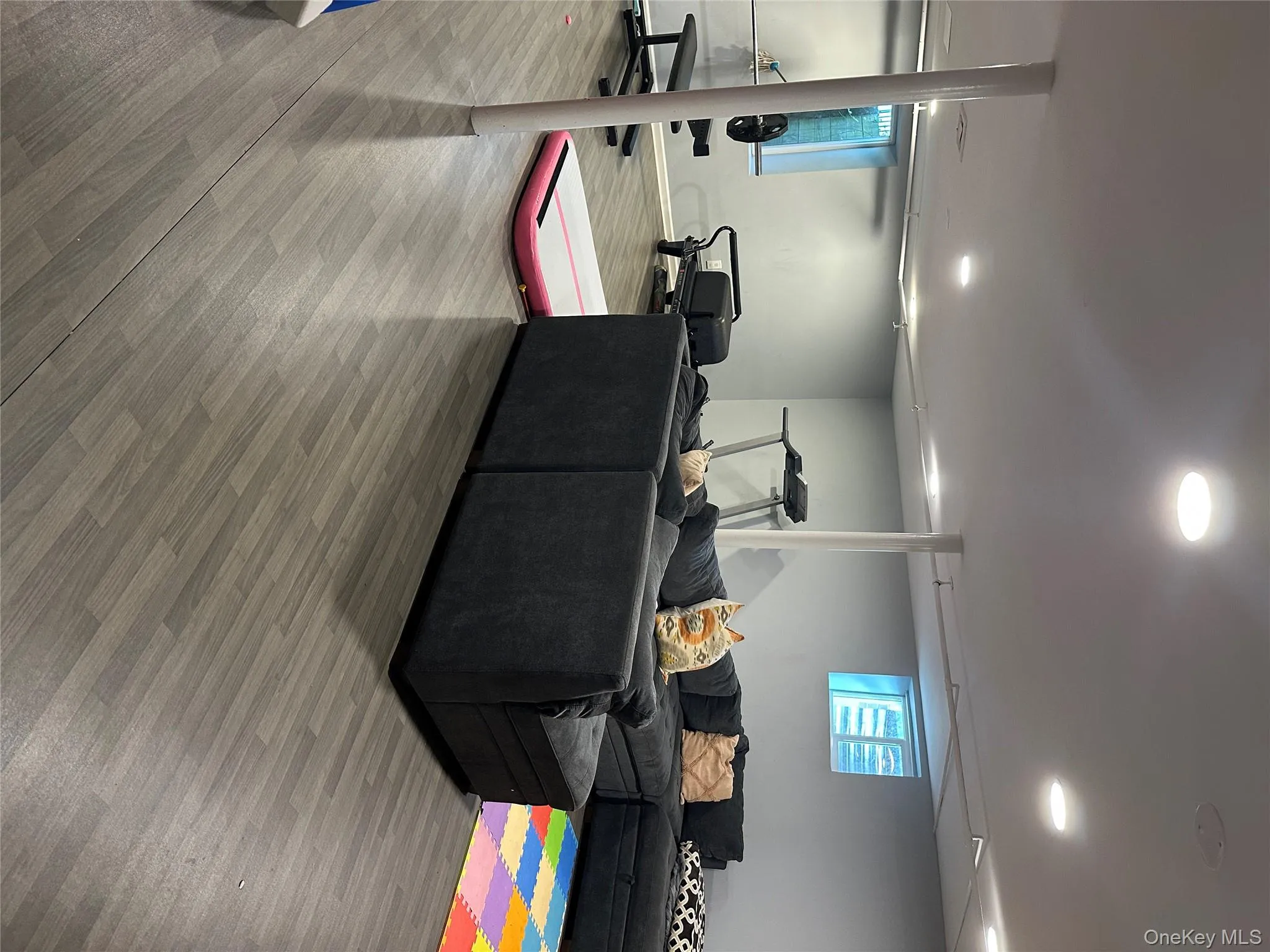 Living area with wood finished floors and recessed lighting Living area with wood finished floors and recessed lighting