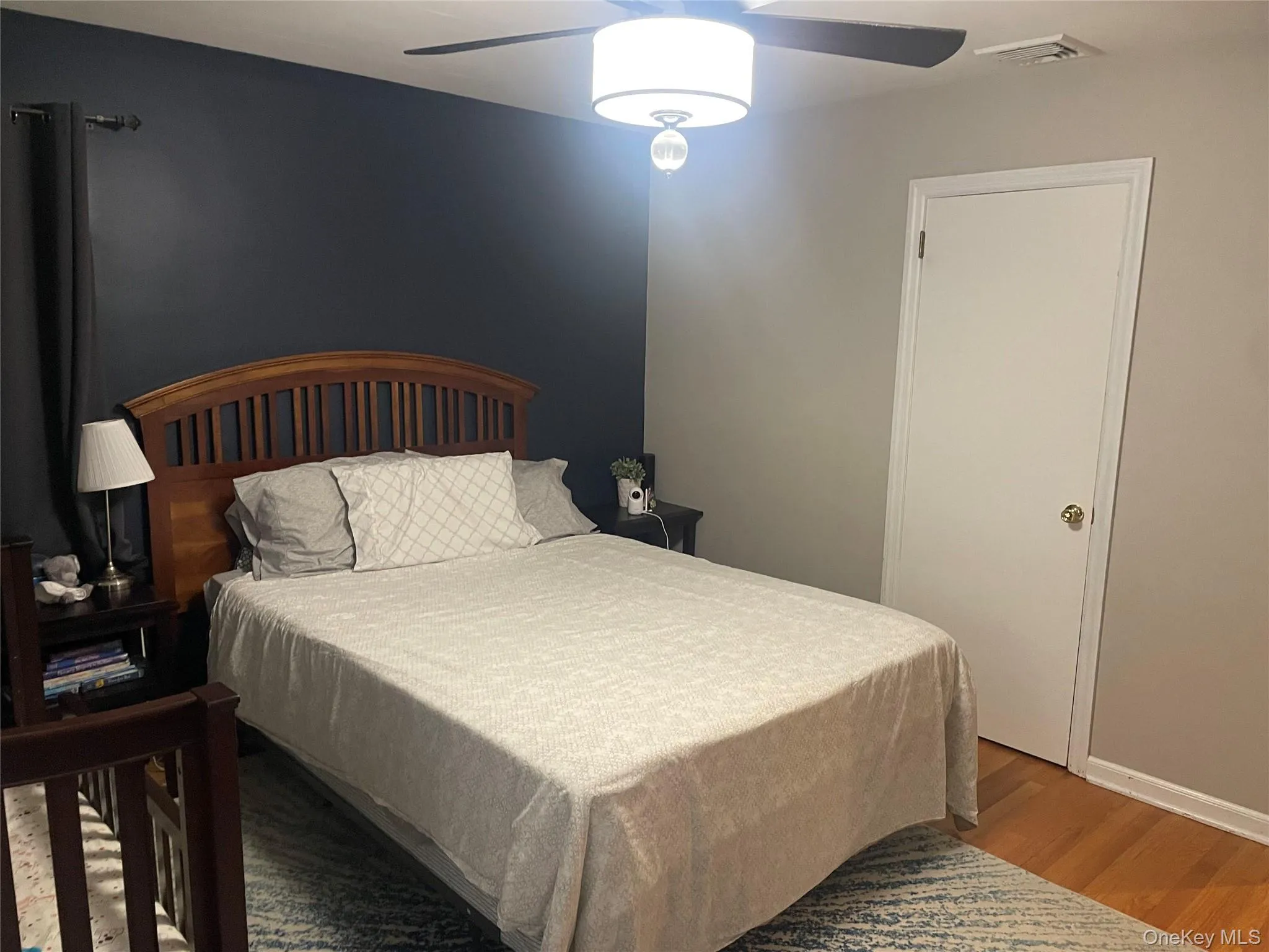Bedroom featuring wood finished floors and ceiling fan Bedroom featuring wood finished floors and ceiling fan