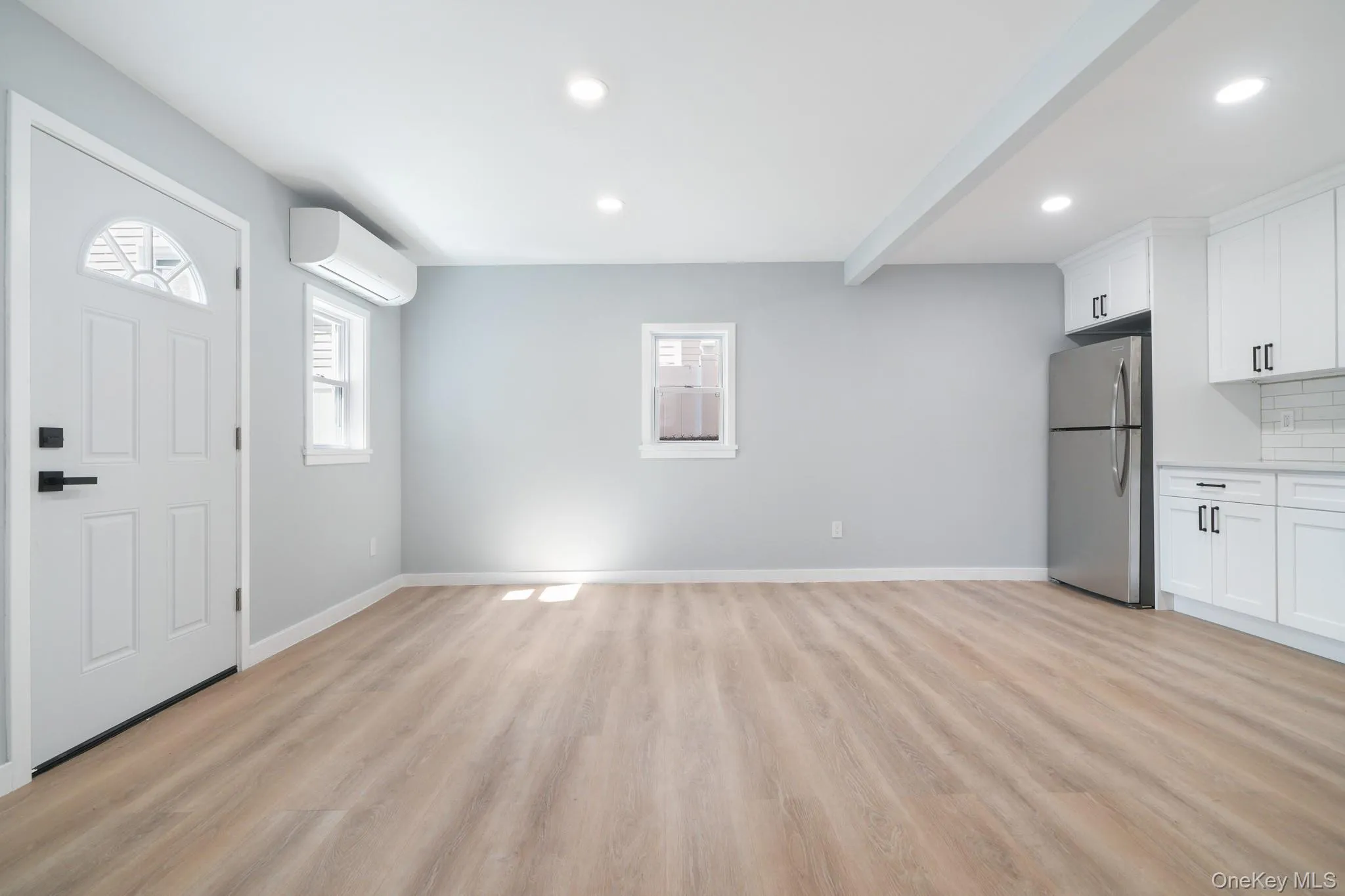 Entryway with beamed ceiling, light wood-style flooring, recessed lighting, and a wall mounted air conditioner Entryway with beamed ceiling, light wood-style flooring, recessed lighting, and a wall mounted air conditioner