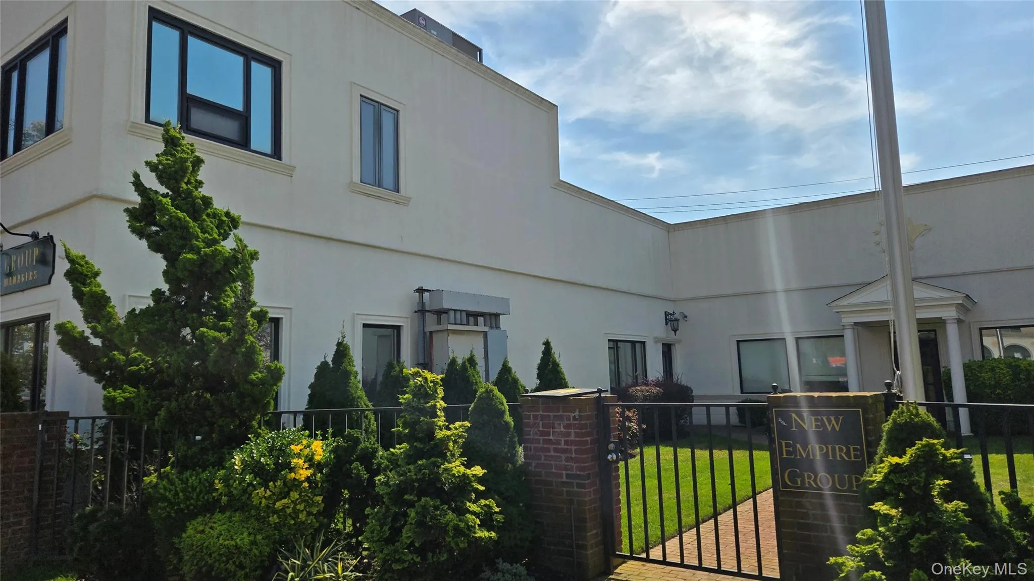 View of building exterior featuring a fenced front yard View of building exterior featuring a fenced front yard