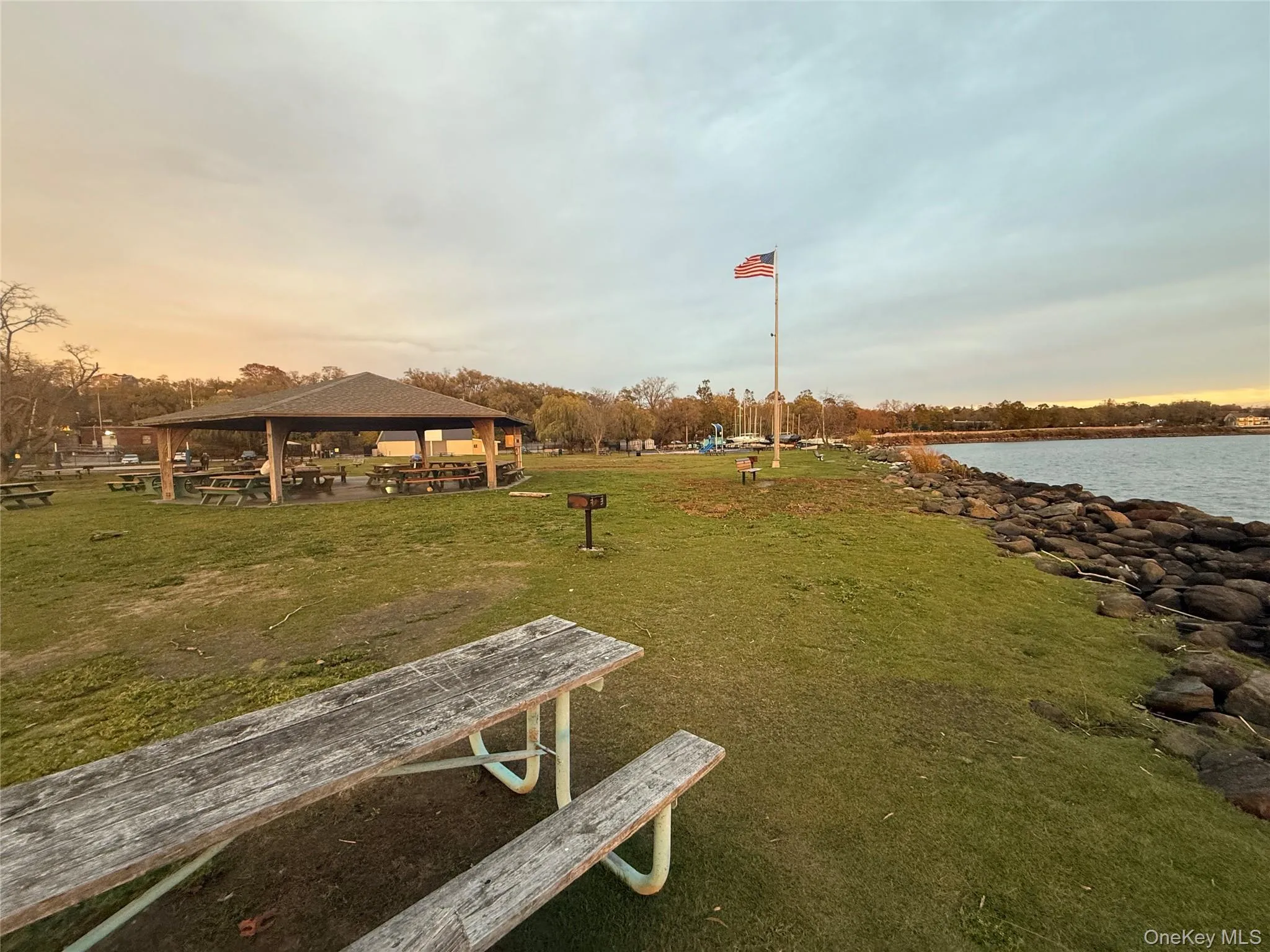 View of property's community featuring a patio area, a water view, and a lawn View of property's community featuring a patio area, a water view, and a lawn