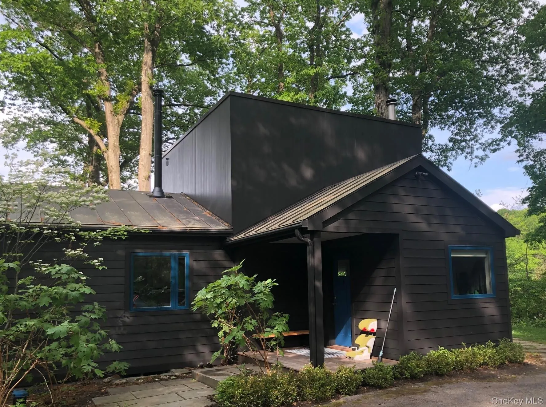 View of front facade featuring a metal roof View of front facade featuring a metal roof