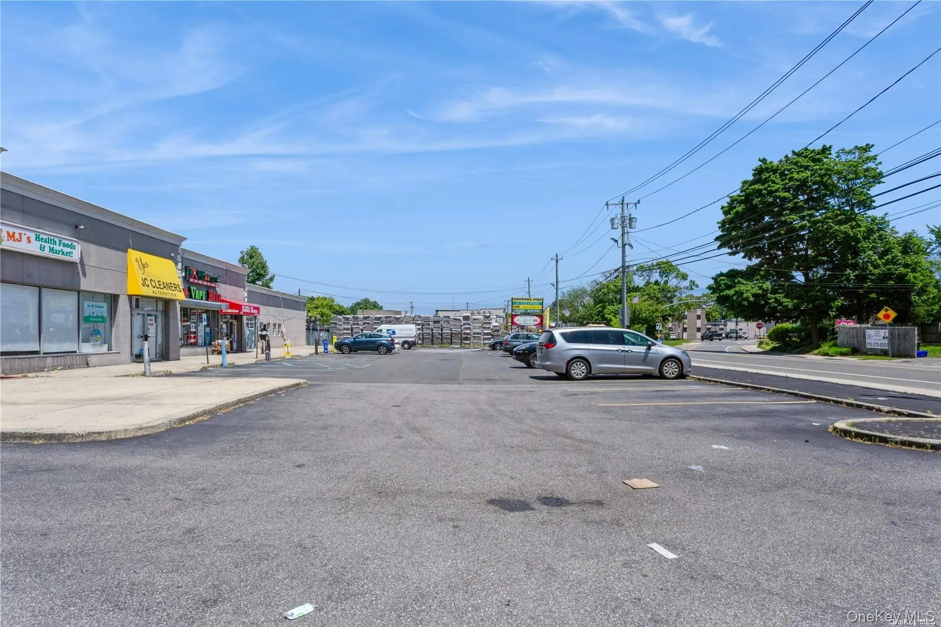 View of asphalt road featuring curbs and sidewalks View of asphalt road featuring curbs and sidewalks