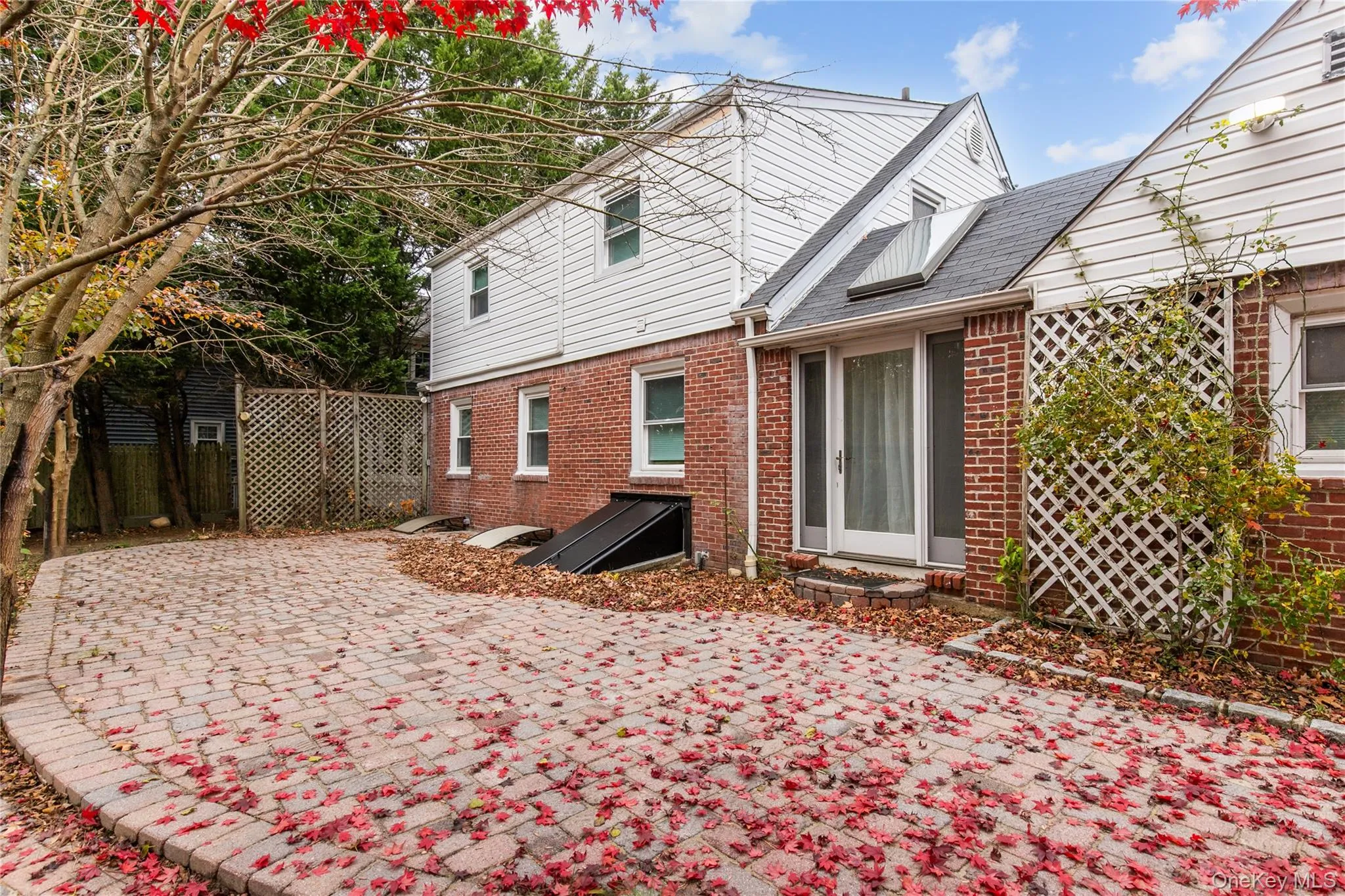 Rear view of property featuring brick siding Rear view of property featuring brick siding