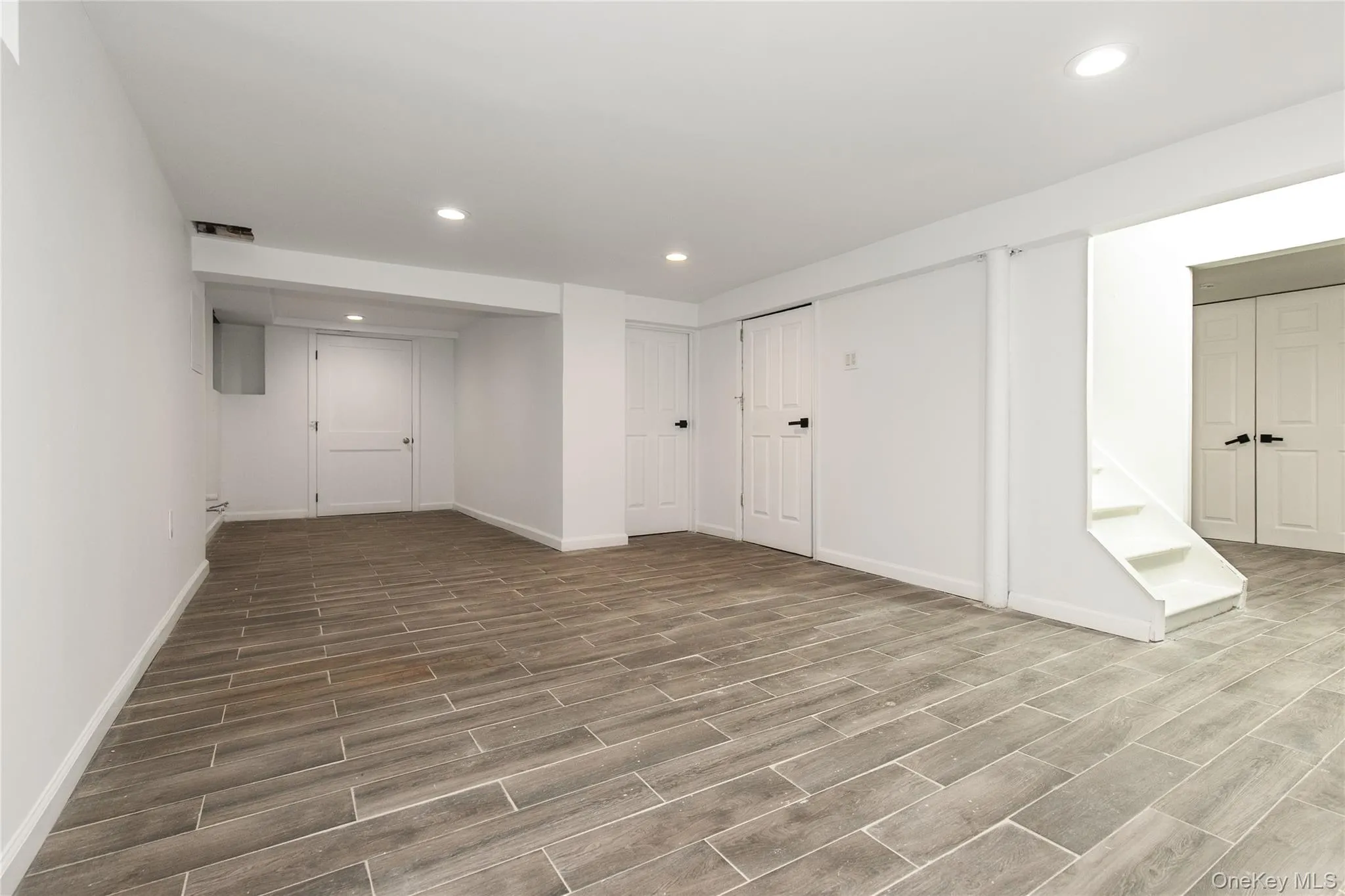 Below grade area with recessed lighting and wood finish floors Below grade area with recessed lighting and wood finish floors