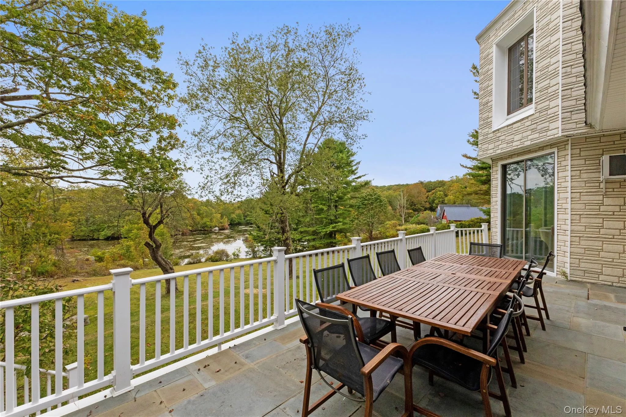 View of patio / terrace featuring outdoor dining space and a water view View of patio / terrace featuring outdoor dining space and a water view