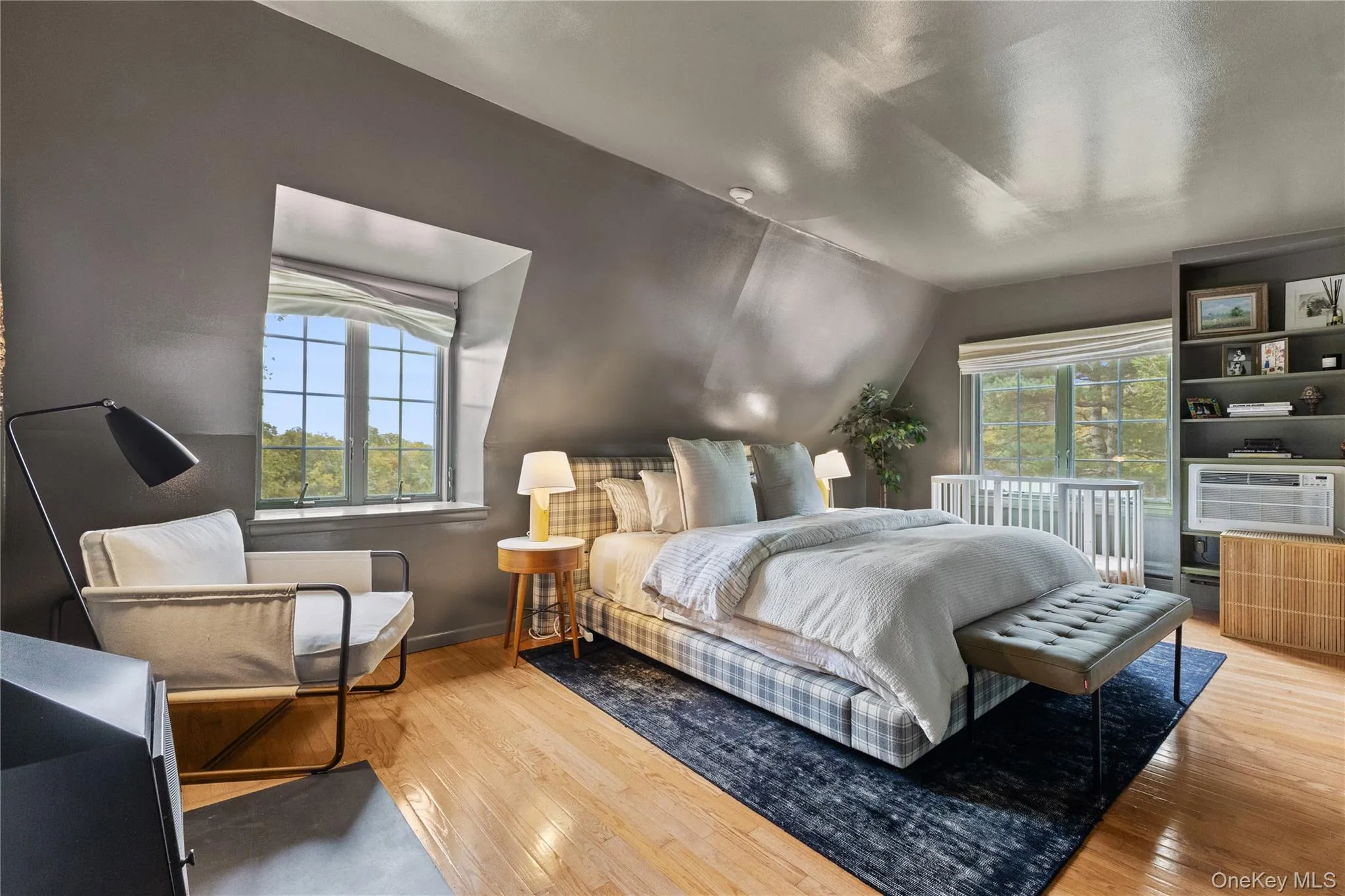 Bedroom with light wood-style floors and lofted ceiling Bedroom with light wood-style floors and lofted ceiling