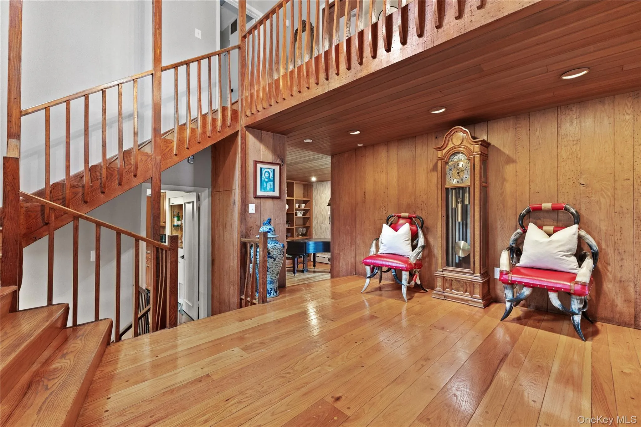 Sitting room featuring wood-type flooring, wooden walls, stairway, recessed lighting, and wood ceiling Sitting room featuring wood-type flooring, wooden walls, stairway, recessed lighting, and wood ceiling