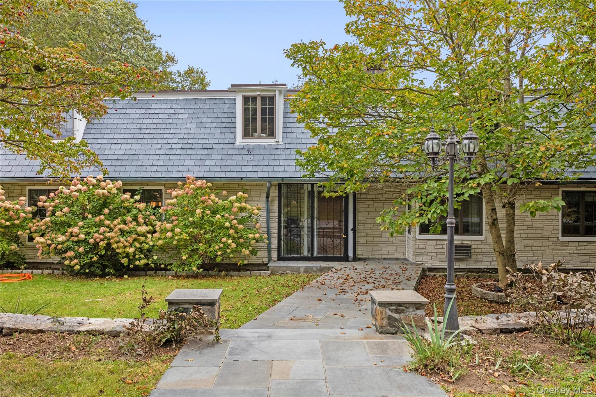 View of front of property with a front yard and brick siding View of front of property with a front yard and brick siding