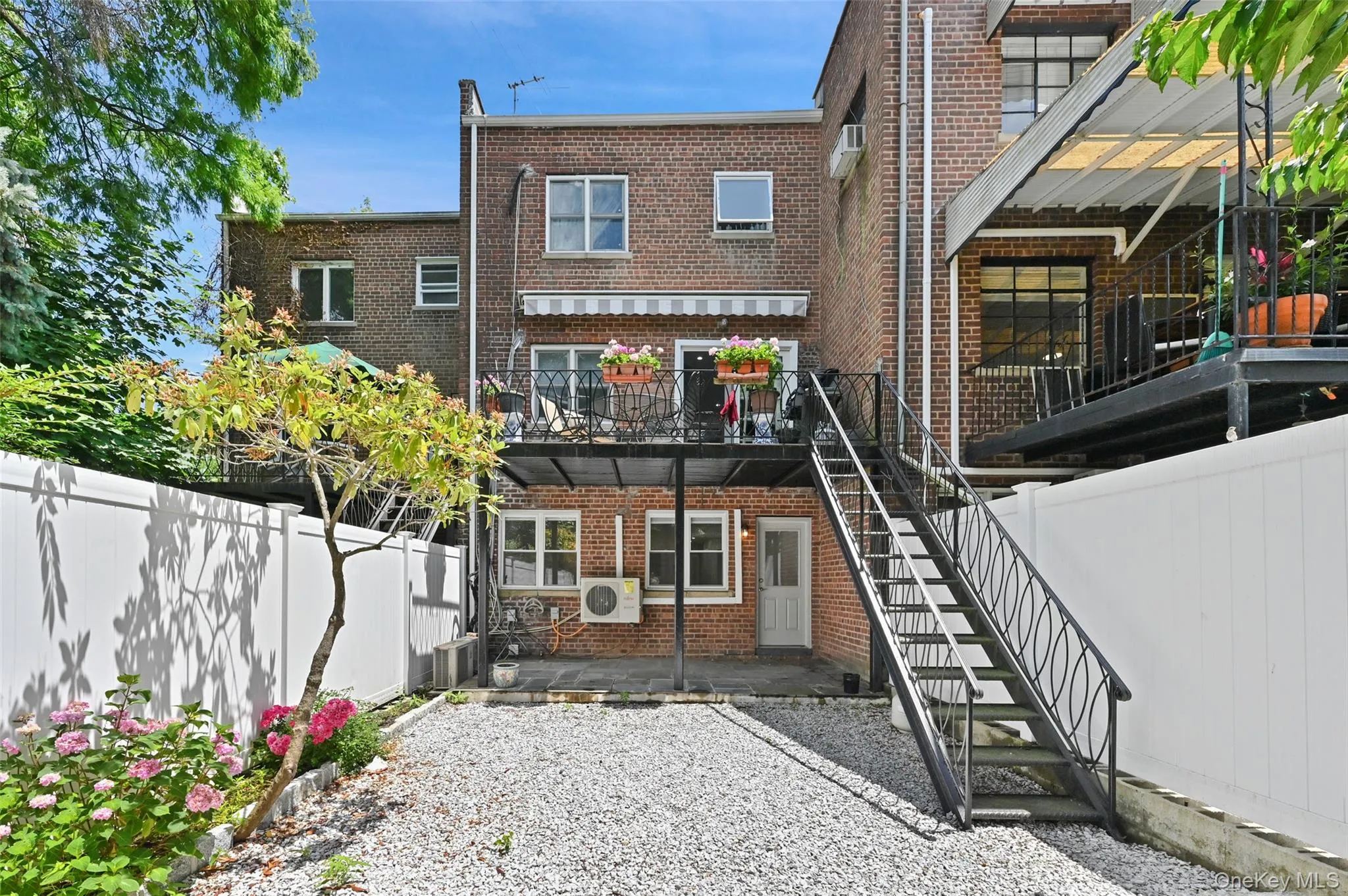 Back of house featuring a patio, stairway, brick siding, a fenced backyard, and a deck Back of house featuring a patio, stairway, brick siding, a fenced backyard, and a deck