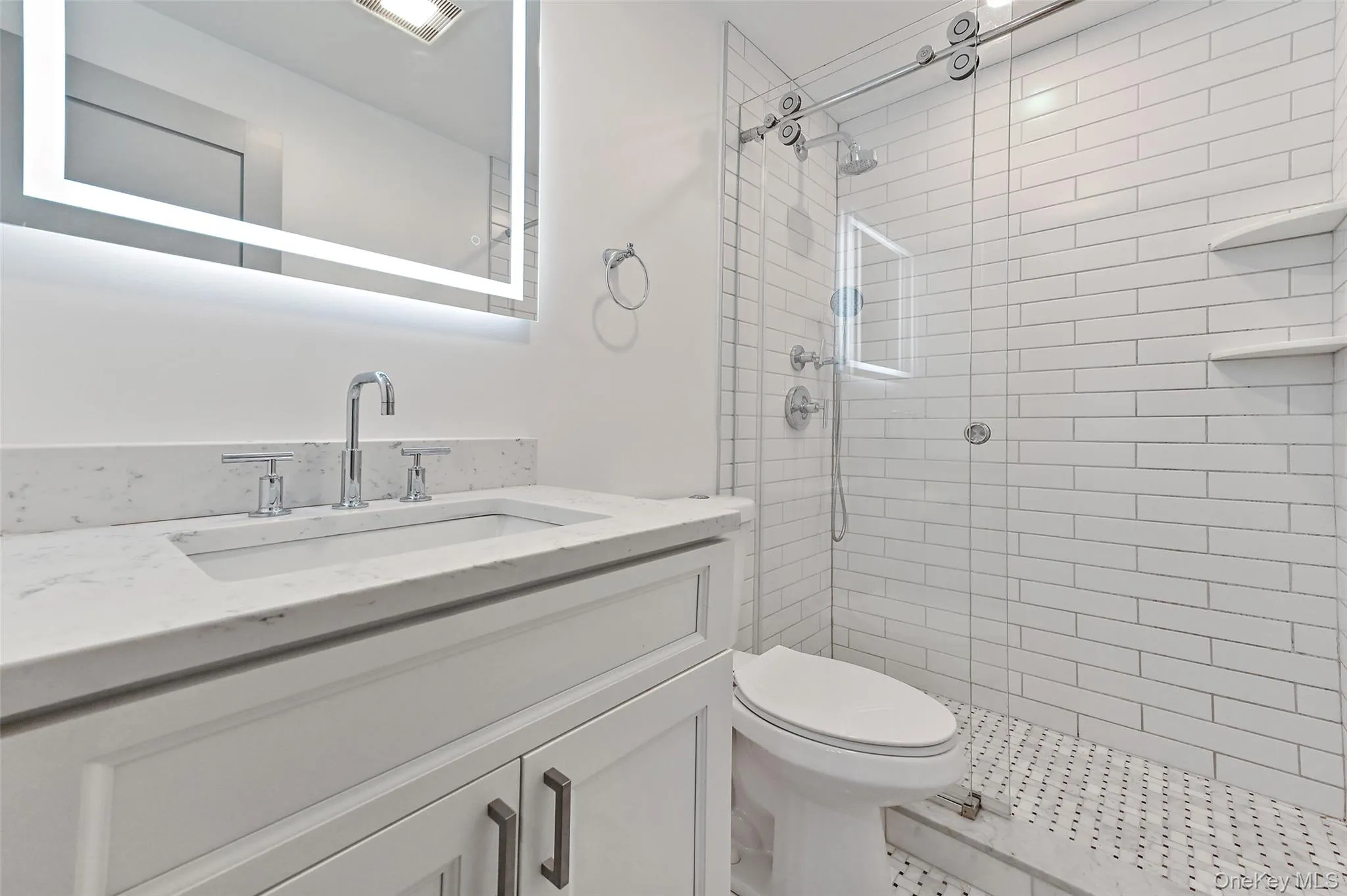 Bathroom with vanity and a shower stall Bathroom with vanity and a shower stall