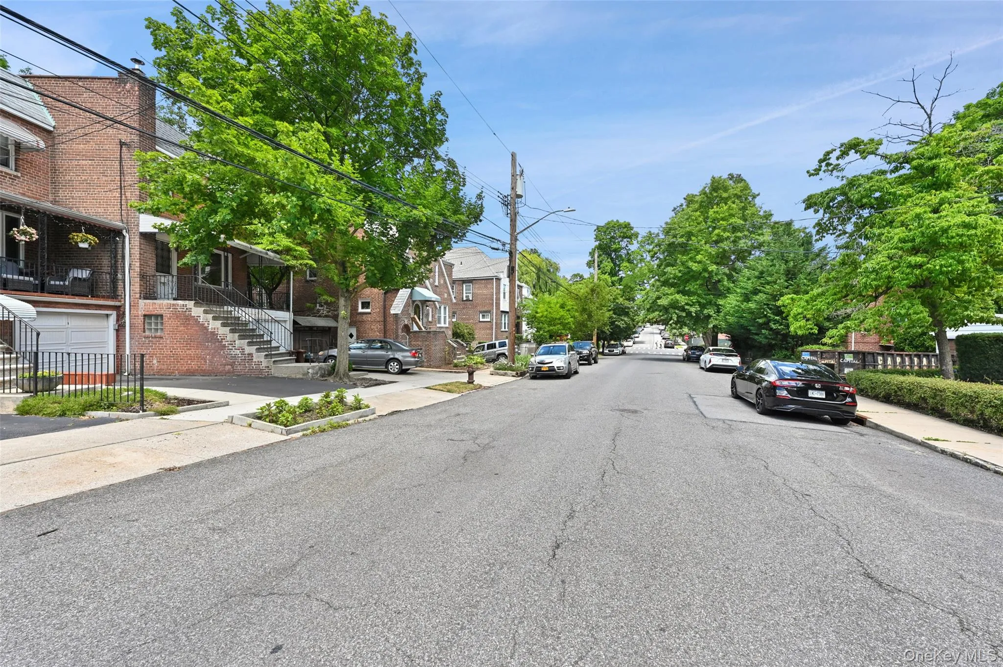 View of asphalt road featuring sidewalks, curbs, and street lights View of asphalt road featuring sidewalks, curbs, and street lights