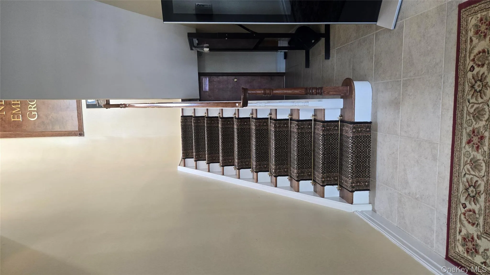 Stairway with baseboards and tile patterned floors Stairway with baseboards and tile patterned floors