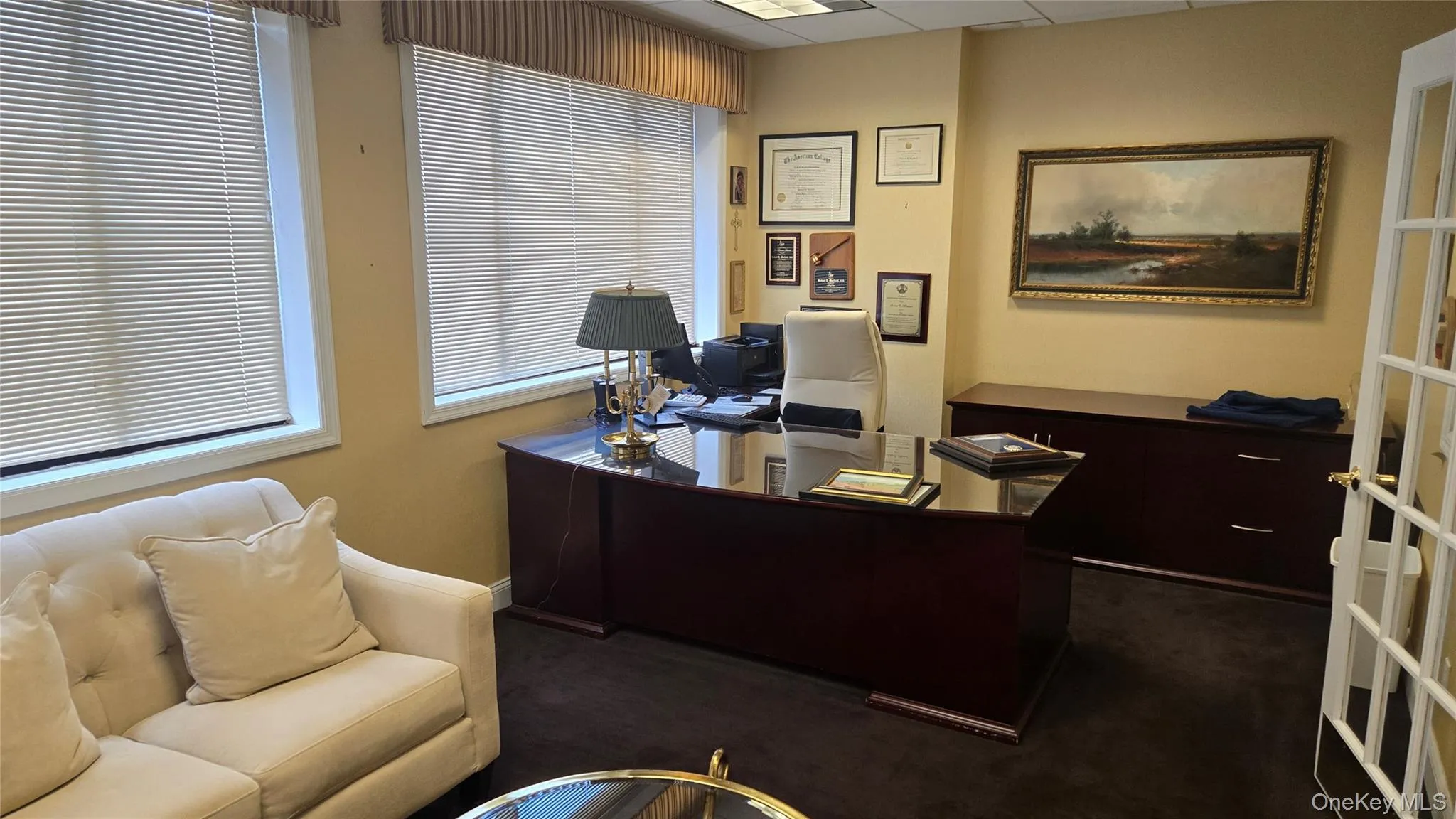 Carpeted office featuring baseboards and a drop ceiling Carpeted office featuring baseboards and a drop ceiling