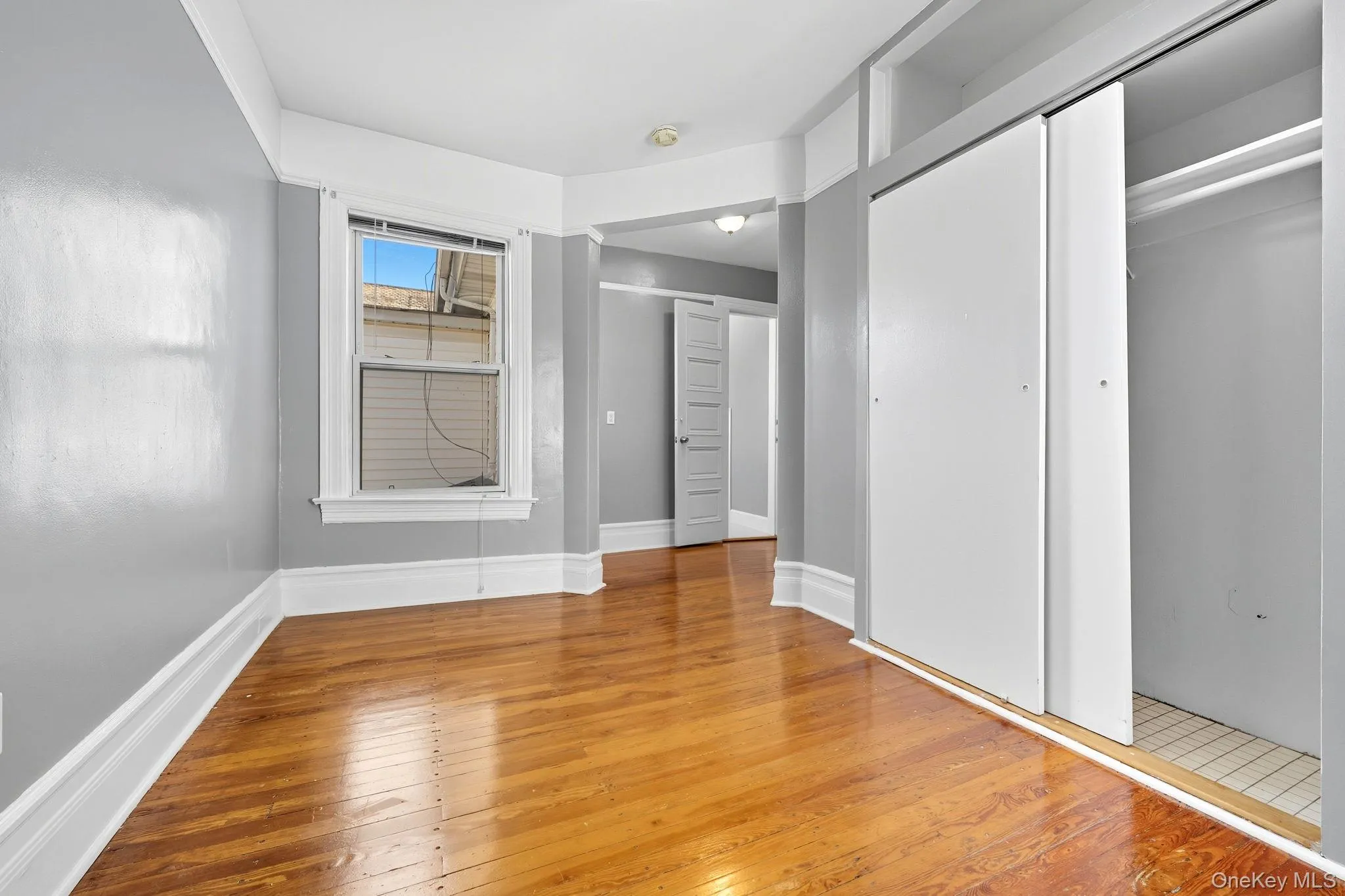 Unfurnished bedroom with light wood-style flooring and a closet Unfurnished bedroom with light wood-style flooring and a closet
