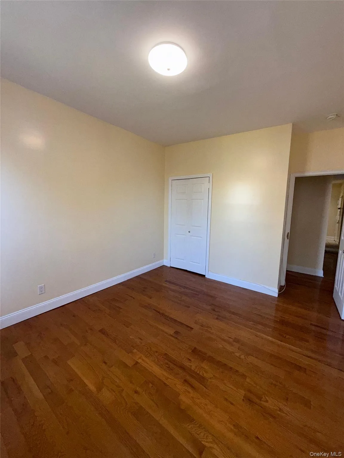 Unfurnished room featuring dark wood-style flooring Unfurnished room featuring dark wood-style flooring